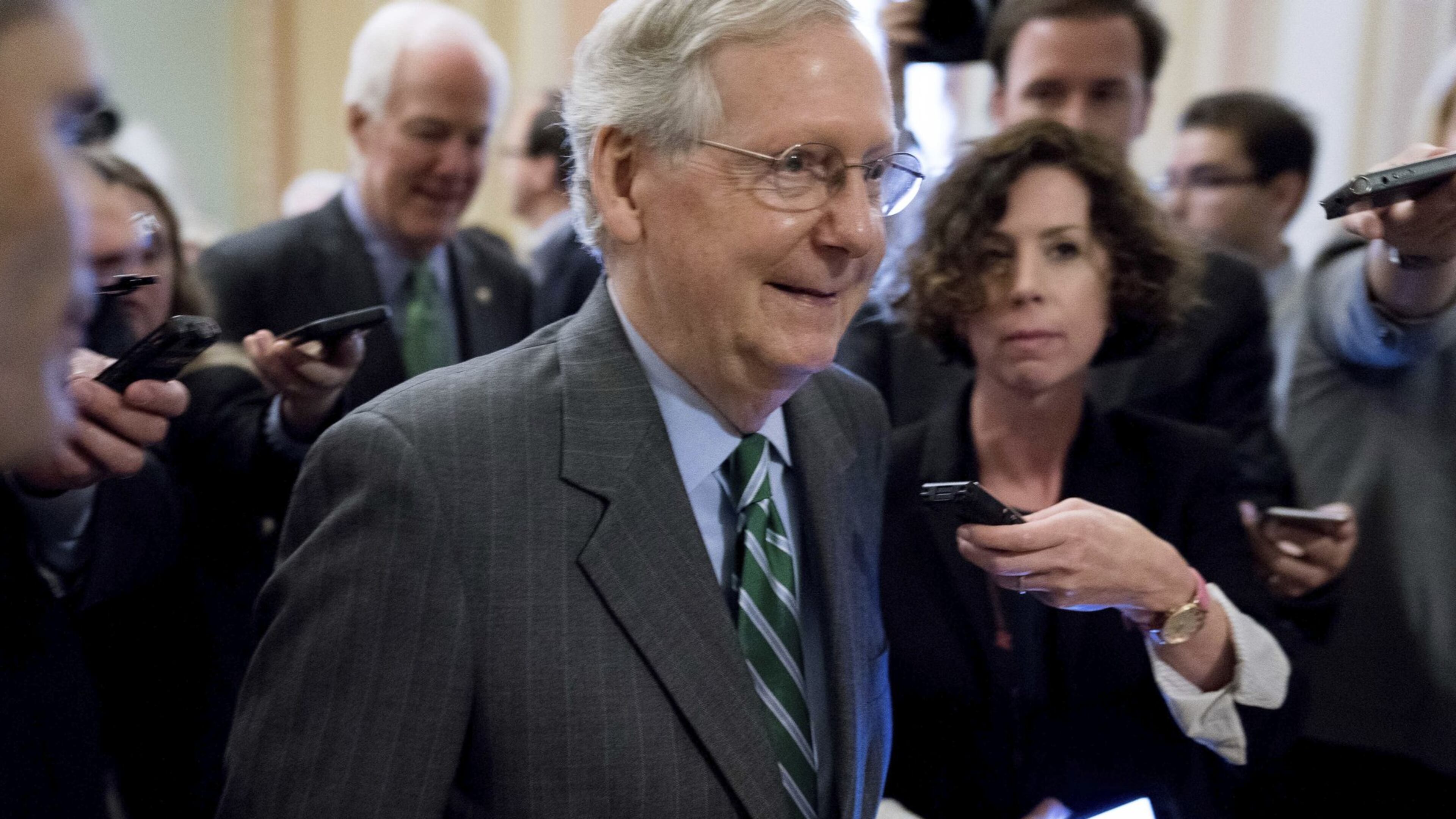 Senate Majority Leader Mitch McConnell of Kentucky walks onto the U.S. Senate floor Thursday following a meeting with Senate Republicans on their long-awaited health care plan. The Congressional Budget Office has now said that plan could lead to 22 million fewer insured Americans, which could include 680,000 Georgians. (AP Photo/Andrew Harnik)