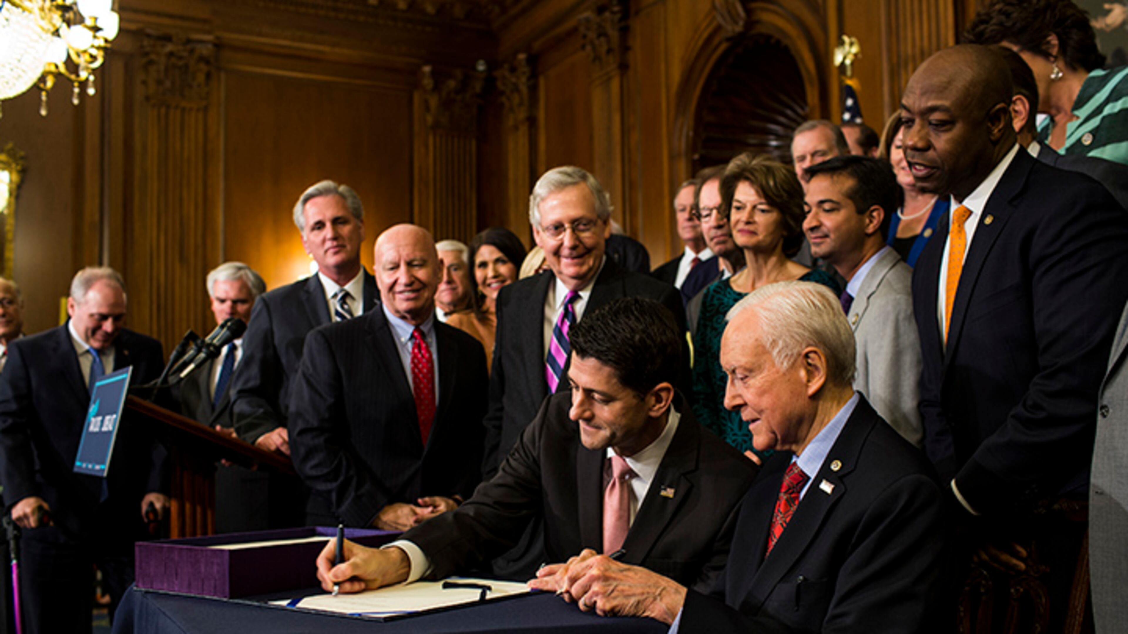 House Speaker Paul Ryan, R-Wis., and Sen. Orrin Hatch, R-Utah, sign an enrollment for the conference report to H.R. 1, the Tax Cuts and Jobs Act, on Capitol Hill in Washington on Dec. 21, 2017.