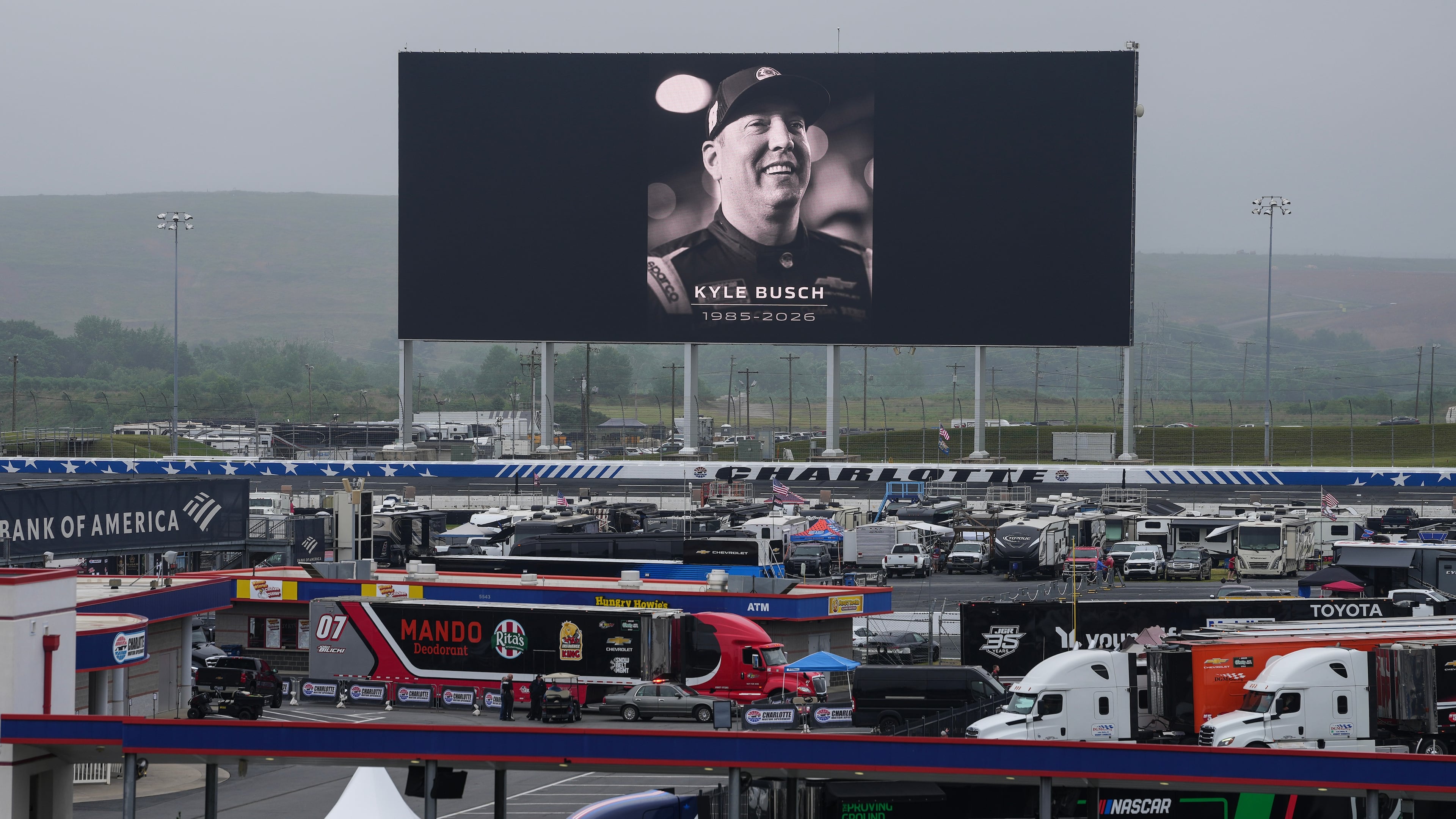 An in memoriam photo of former driver Kyle Busch is displayed on the video board of the backstretch at Charlotte Motor Speedway, Friday, May 22, 2026, in Charlotte, N.C. (AP Photo/Matt Kelley)