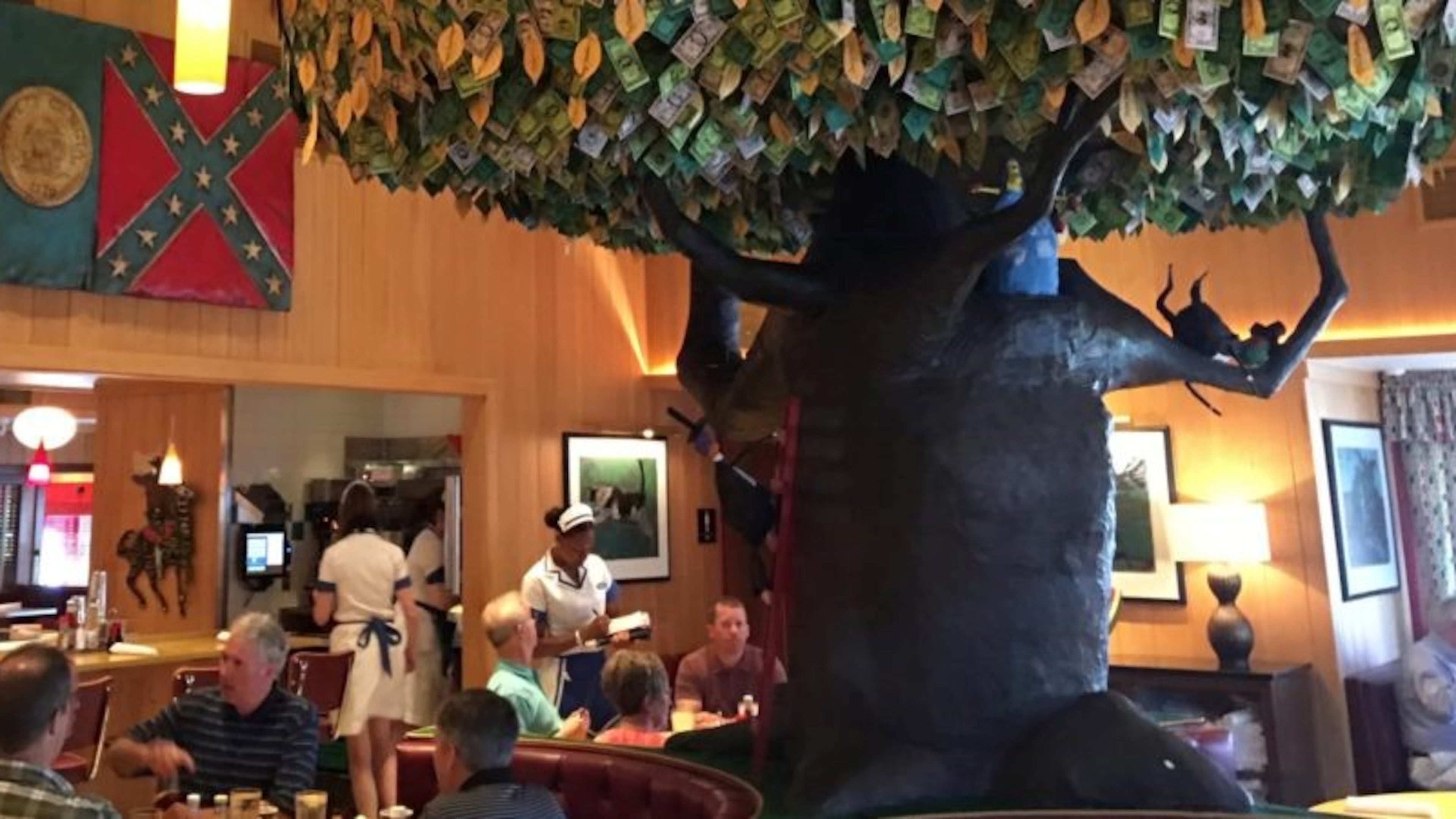 The wood carving of Georgia's 1956 state flag, complete with Rebel emblem, was moved to the back dining area. Courtesy Tony Wilbert.