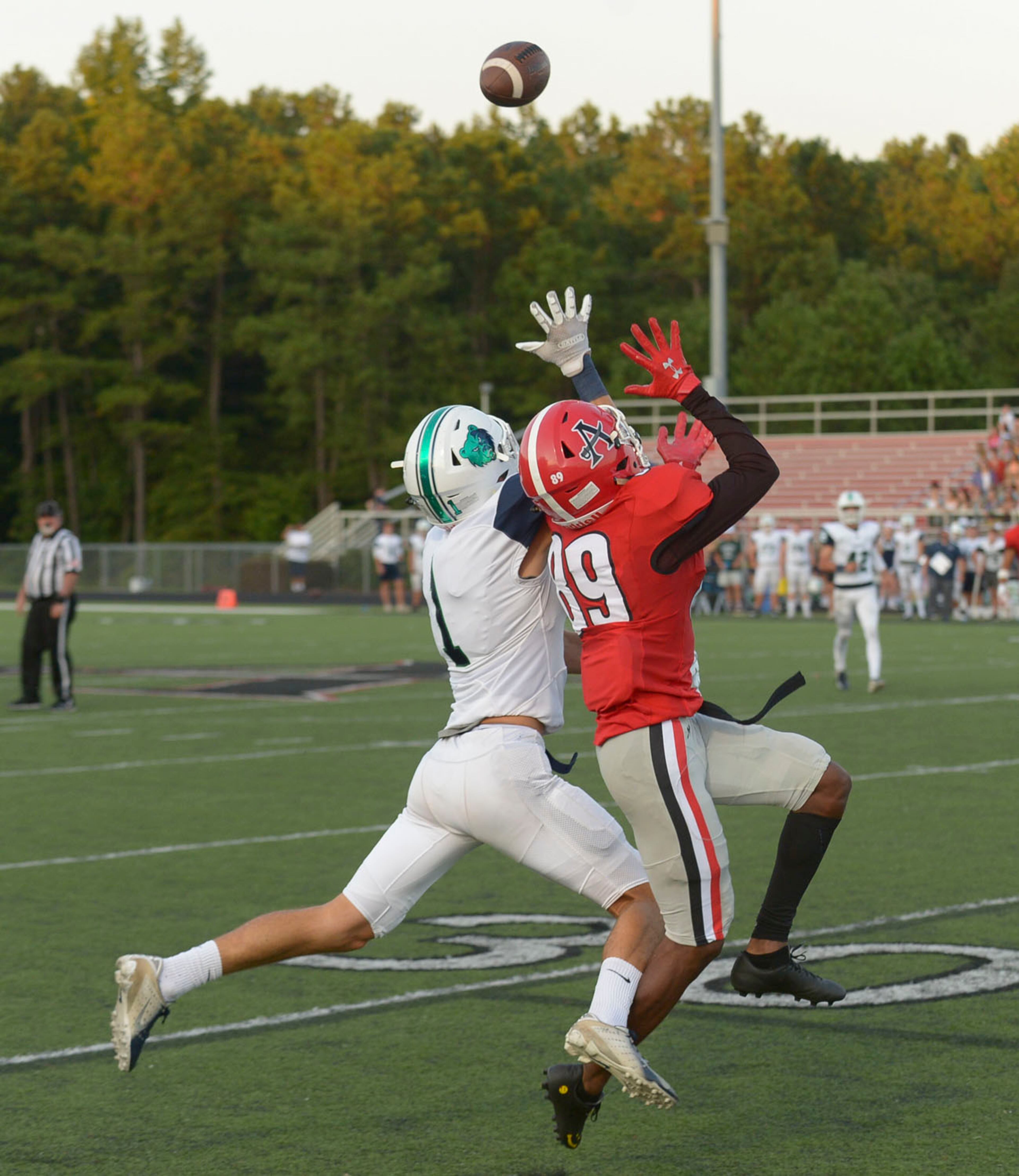 Creekview wide receiver Jake Kaminsky (1) and Allatoona wide receiver Ty Bouyer (89) battle for a mid-air catch in the first half of their game at Allatoona High. (Daniel Varnado/Special)