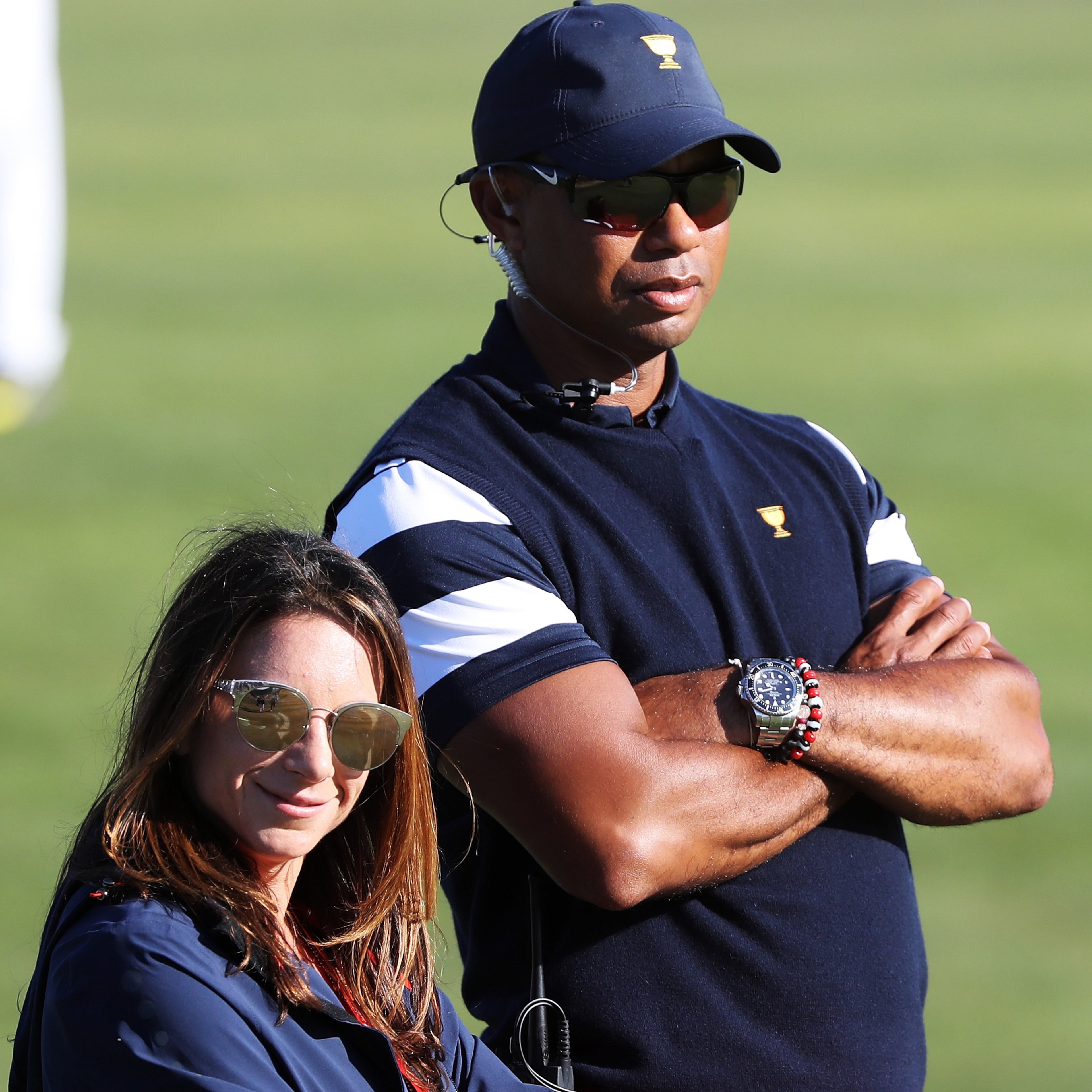 Captain's assistant Tiger Woods of the U.S. Team and Erica Herman look on during Sunday singles matches of the Presidents Cup Oct. 1, 2017, at Liberty National Golf Club on in Jersey City, N.J.