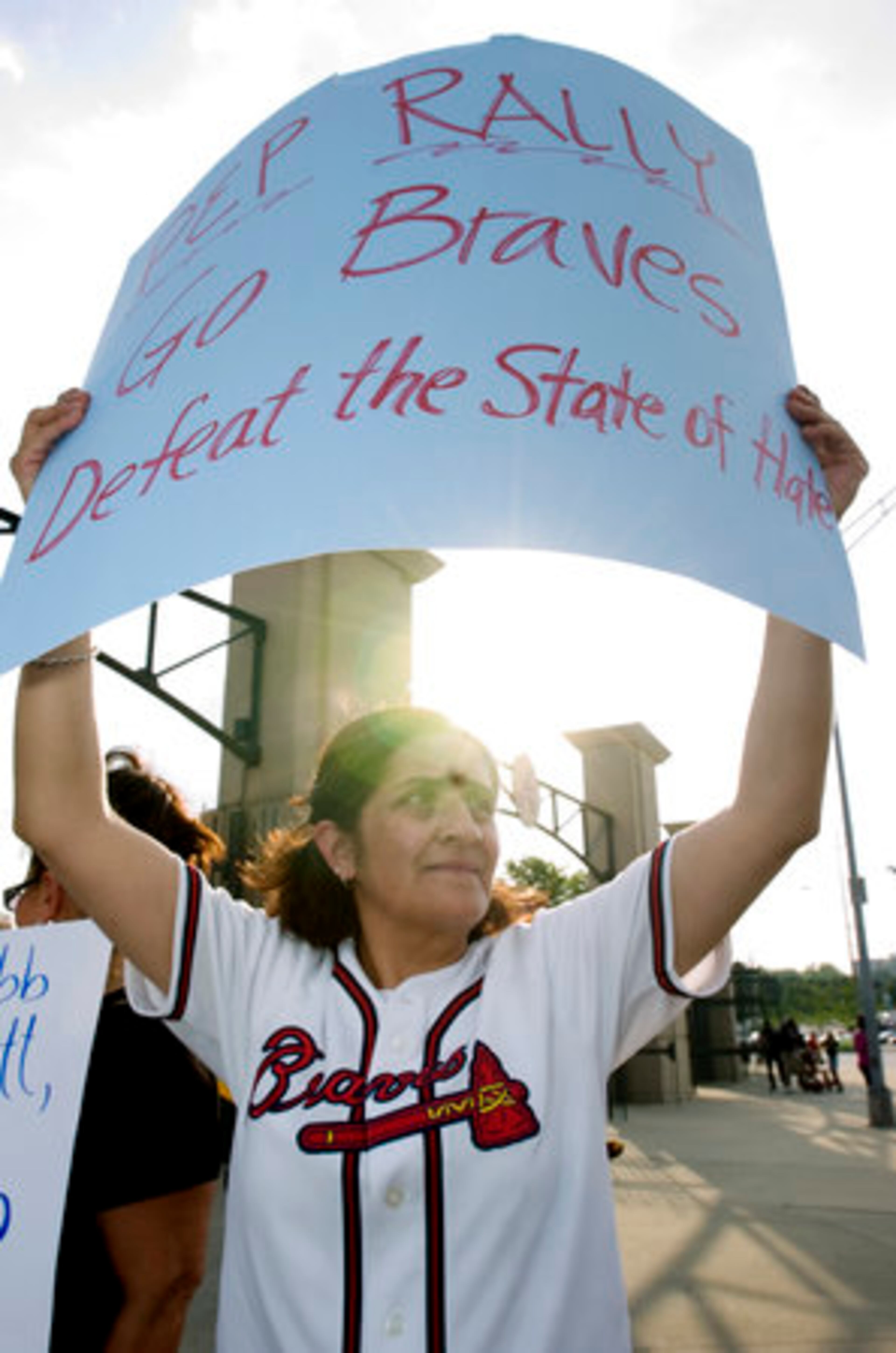 The Atlanta Braves played the Arizona Diamondbacks on Saturday. Adelina Nichols of the Georgia Latino Alliance of Human Rights holds a poster protesting Arizona's immigration law.
