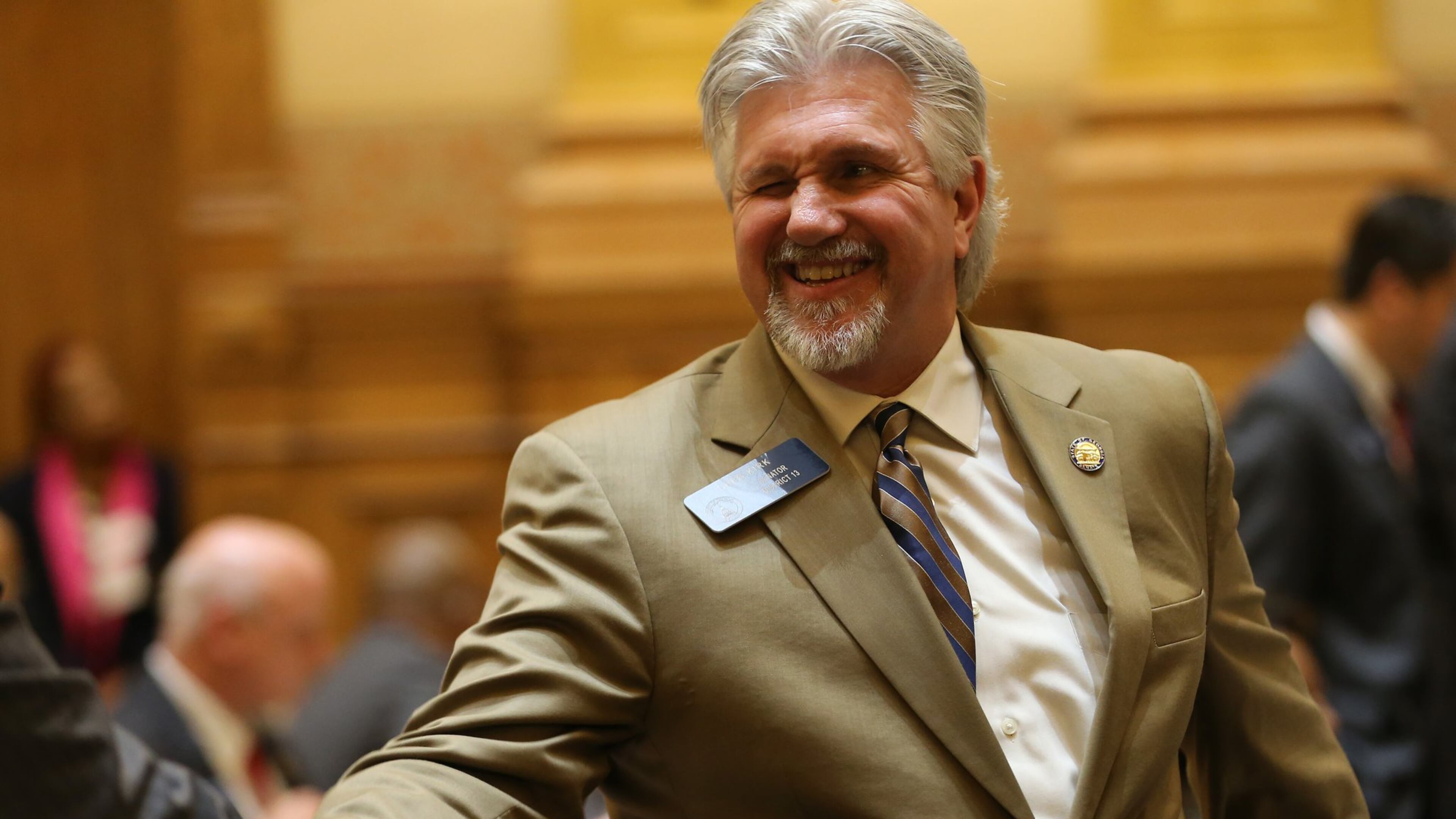 Sen. Greg Kirk (R-Americus) winks and shakes hands after the “religious liberty” bill he sponsored in the Senate passed on March 16. Ben Gray / bgray@ajc.com