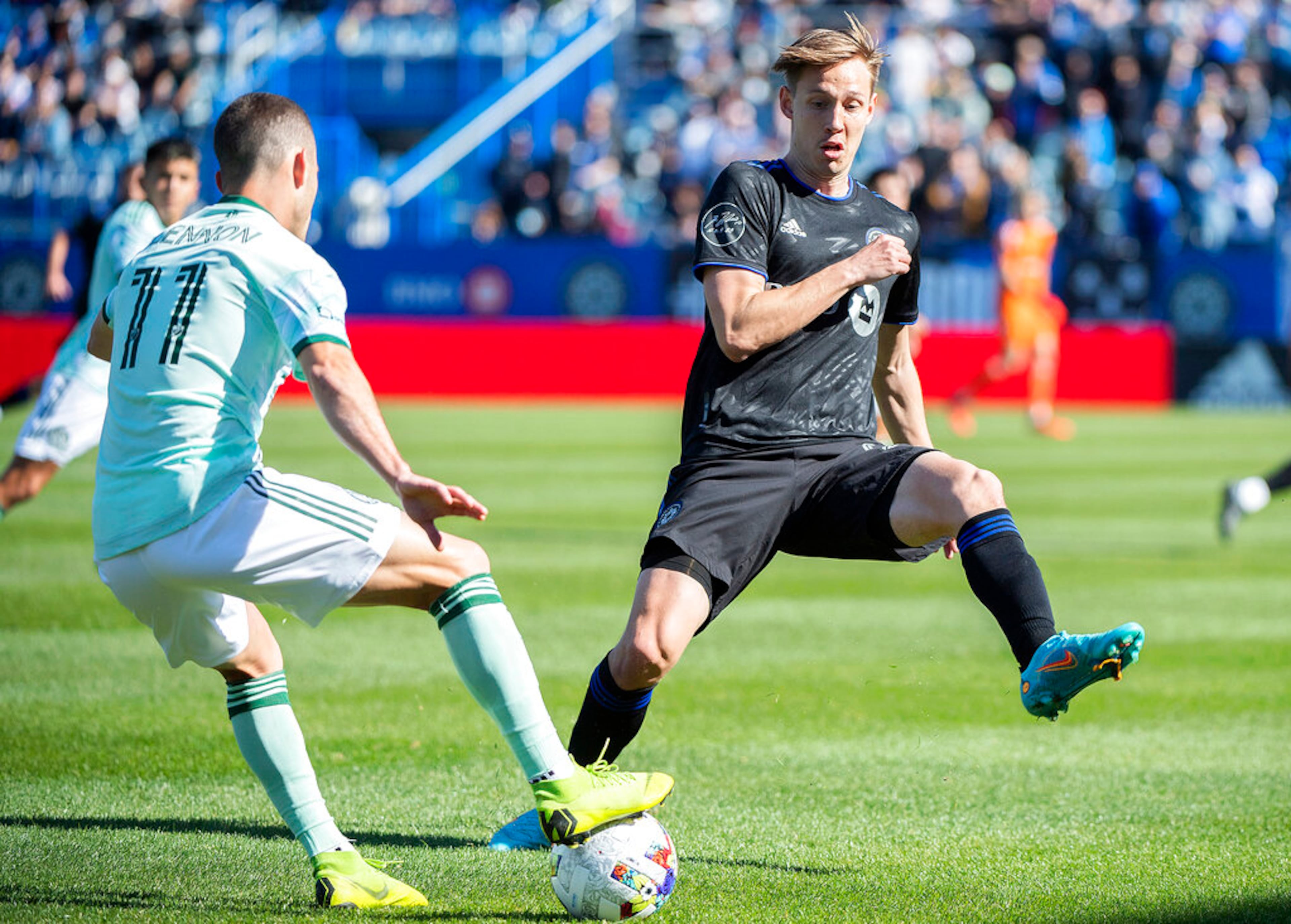 CF Montreal's Lassi Lappalainen, right, challenges Atlanta United's Brooks Lennon during the first half of a MLS soccer game in Montreal, Saturday, April 30, 2022. (Graham Hughes/The Canadian Press via AP)
