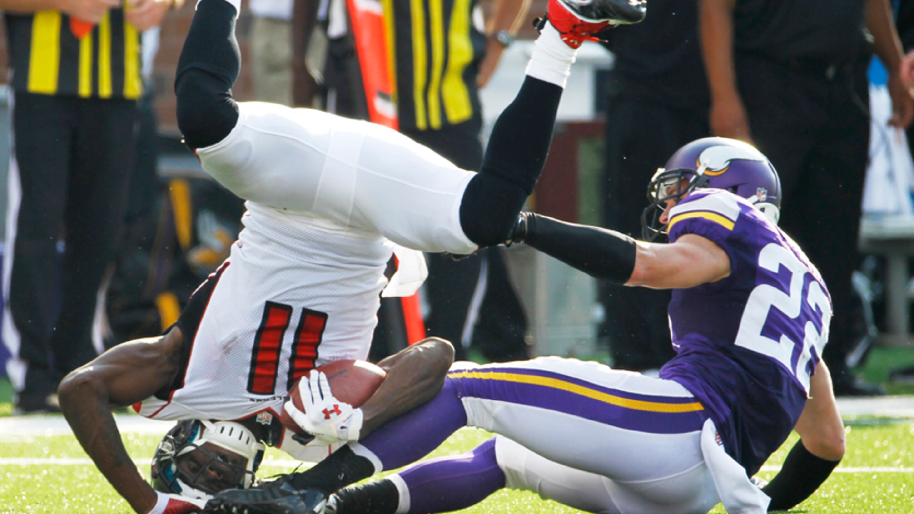 Atlanta Falcons wide receiver Julio Jones (11) is tackled by Minnesota Vikings free safety Harrison Smith during the first half of an NFL football game, Sunday, Sept. 28, 2014, in Minneapolis. (AP Photo/Ann Heisenfelt)