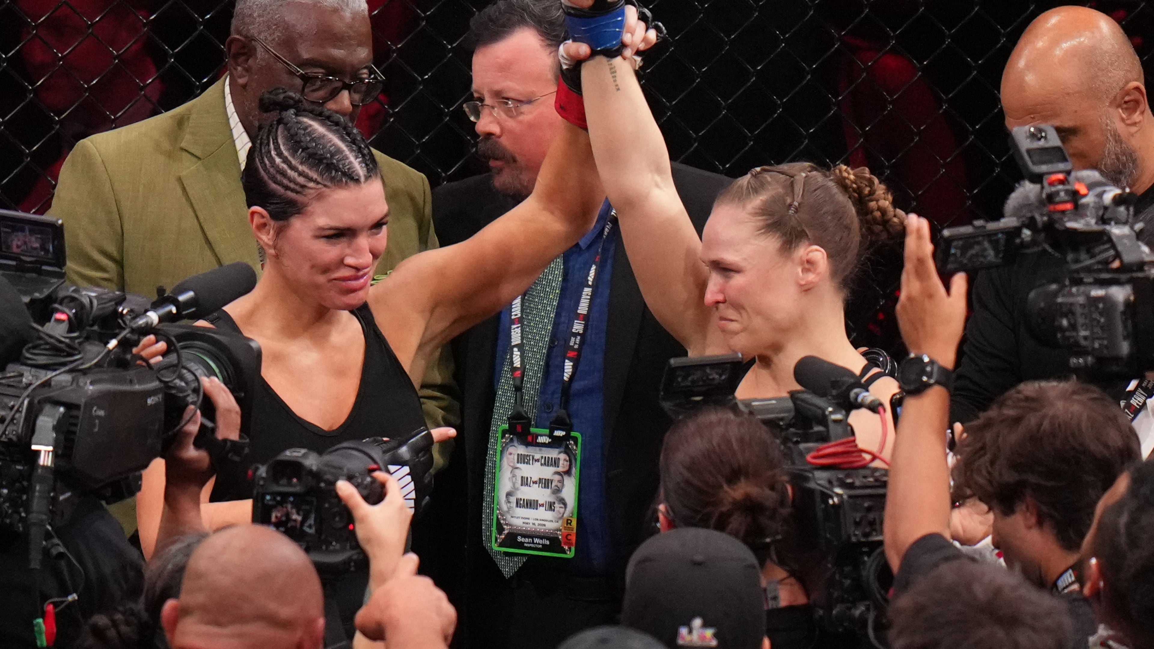Ronda Rousey, of the United States, right, celebrates after defeating Gina Carano, of the United States, left, in their featherweight mixed martial arts fight Saturday, May 16, 2026, in Inglewood, Calif. (AP Photo/Jae C. Hong )
