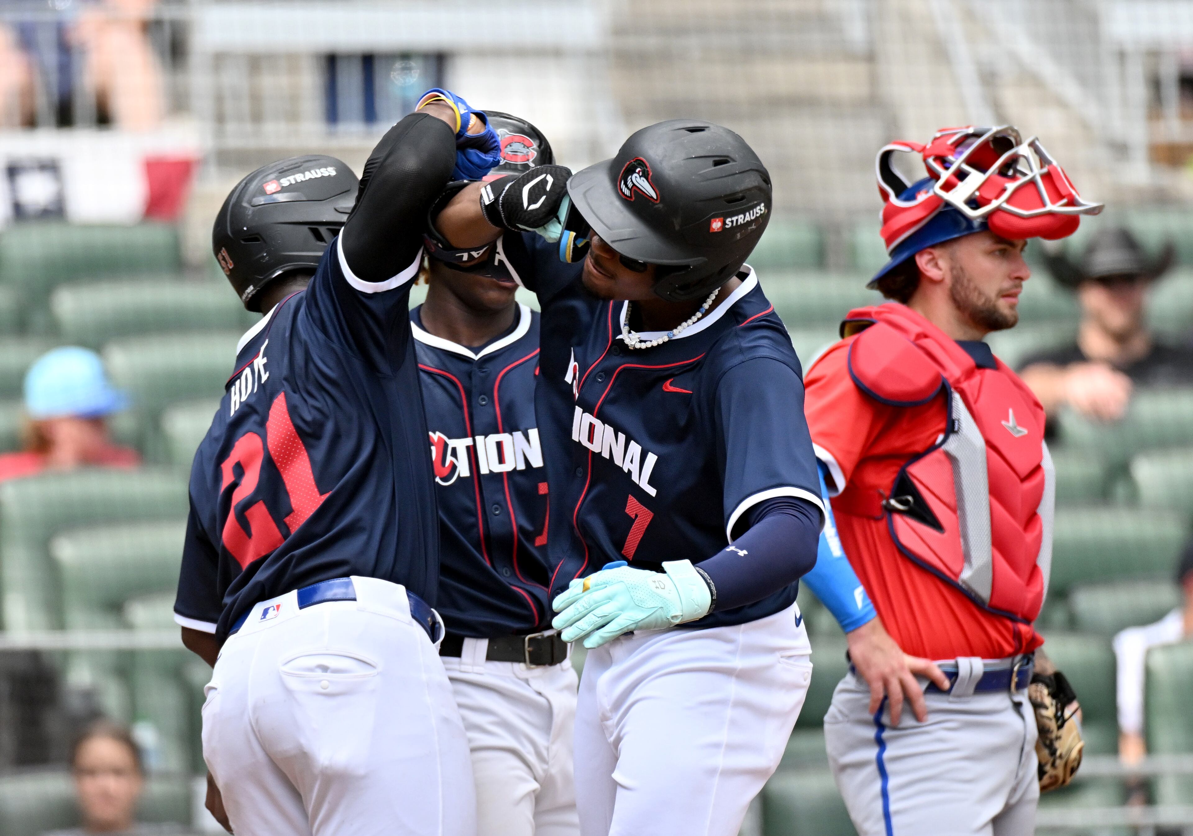 National League outfielder Josue De Paula (7) celebrates with teammates after hitting a 3-run home run during the fourth inning of the All-Star Futures Game at Truist Park, Saturday, July 12, 2025, in Atlanta. National League won 4-2 over American League. (Hyosub Shin / AJC)