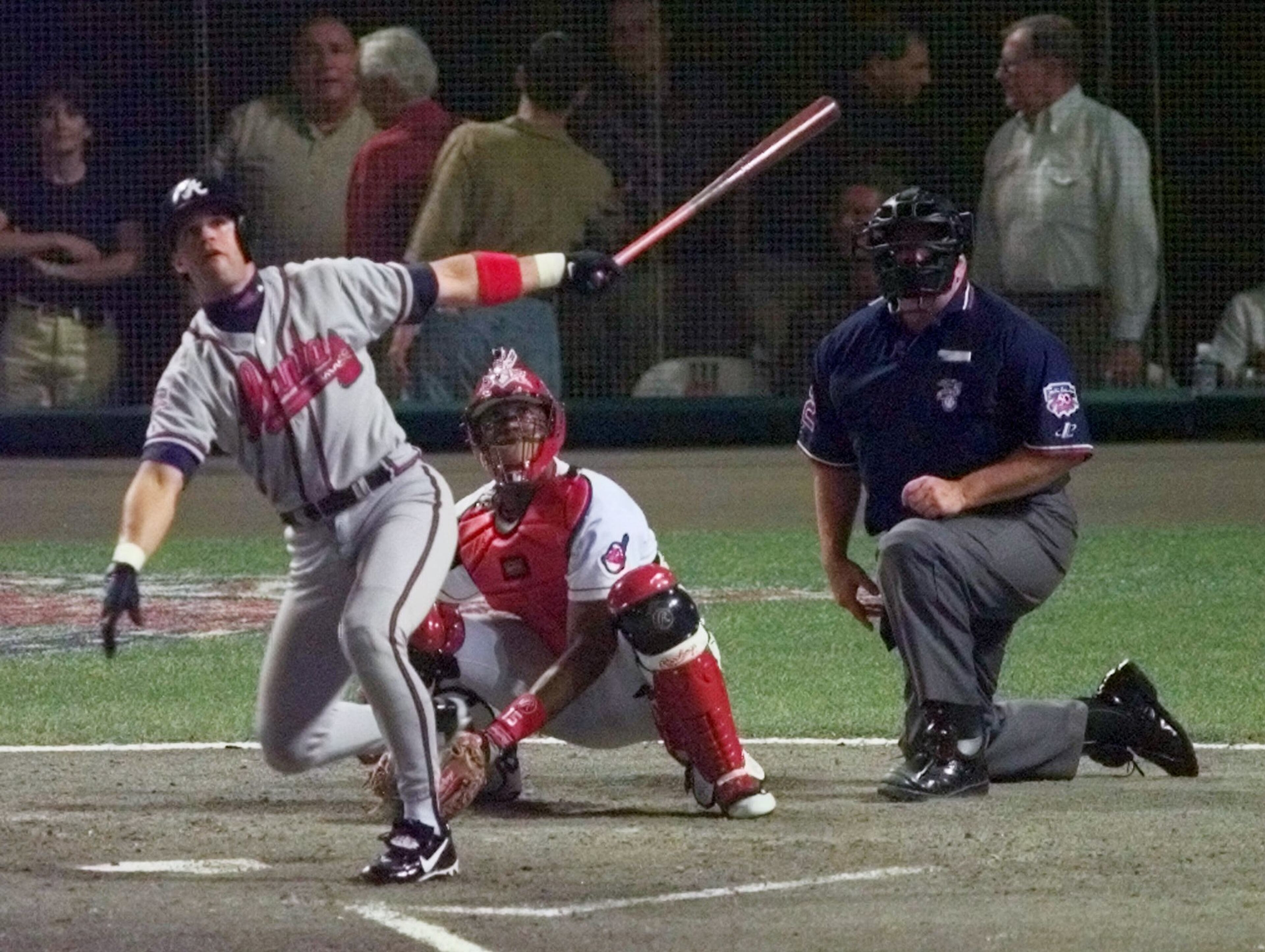 Braves' Javy Lopez watches his solo home run along with Cleveland Indians catcher Sandy Alomar and home plate umpire Larry Barnett in the seventh inning of the 68th All-Star Game Tuesday, July 8, 1997 in Cleveland.