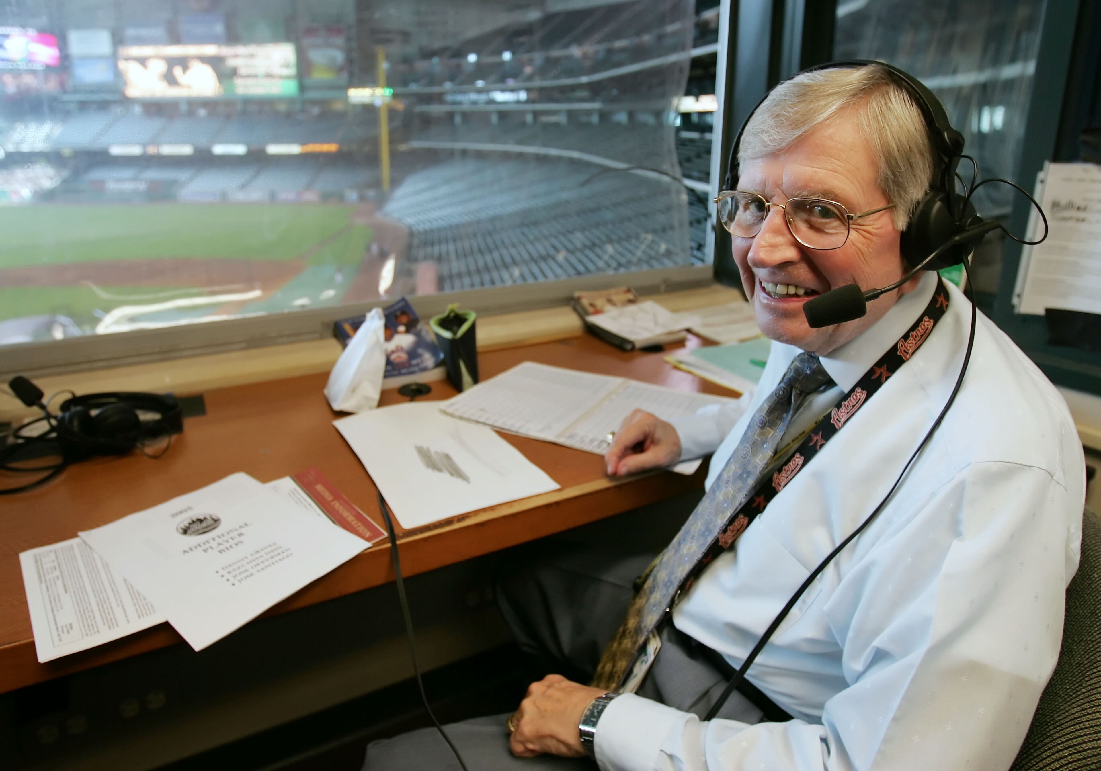 Milo Hamilton takes a break from his pre-game routine as he smiles in his radio booth before a baseball game in Houston in 2005. (AP Photo/David J. Phillip, File)