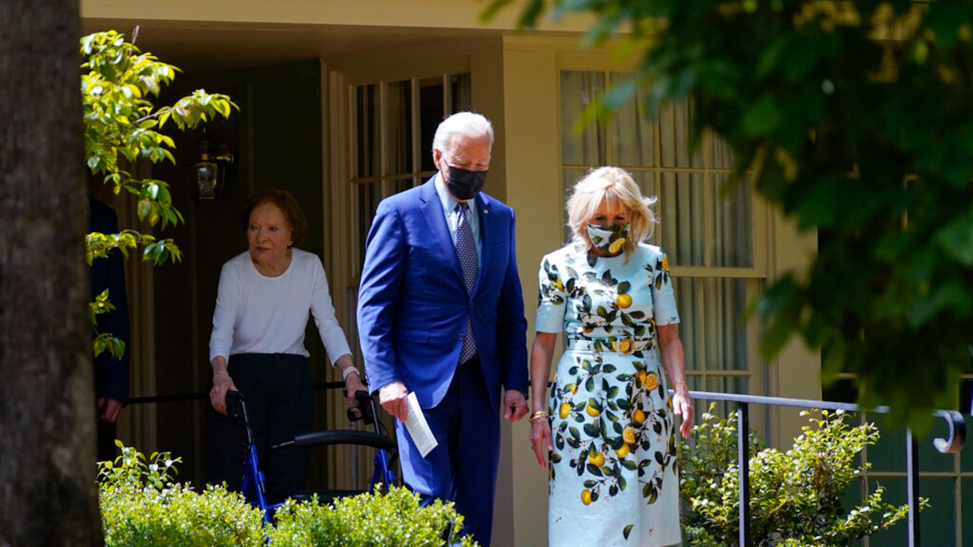 President Joe Biden and first lady Jill Biden walk with former first lady Rosalynn Carter as they leave the home of former President Jimmy Carter during a trip to mark Biden's 100th day in office, Thursday, April 29, 2021, in Plains, Ga. (AP Photo/Evan Vucci)