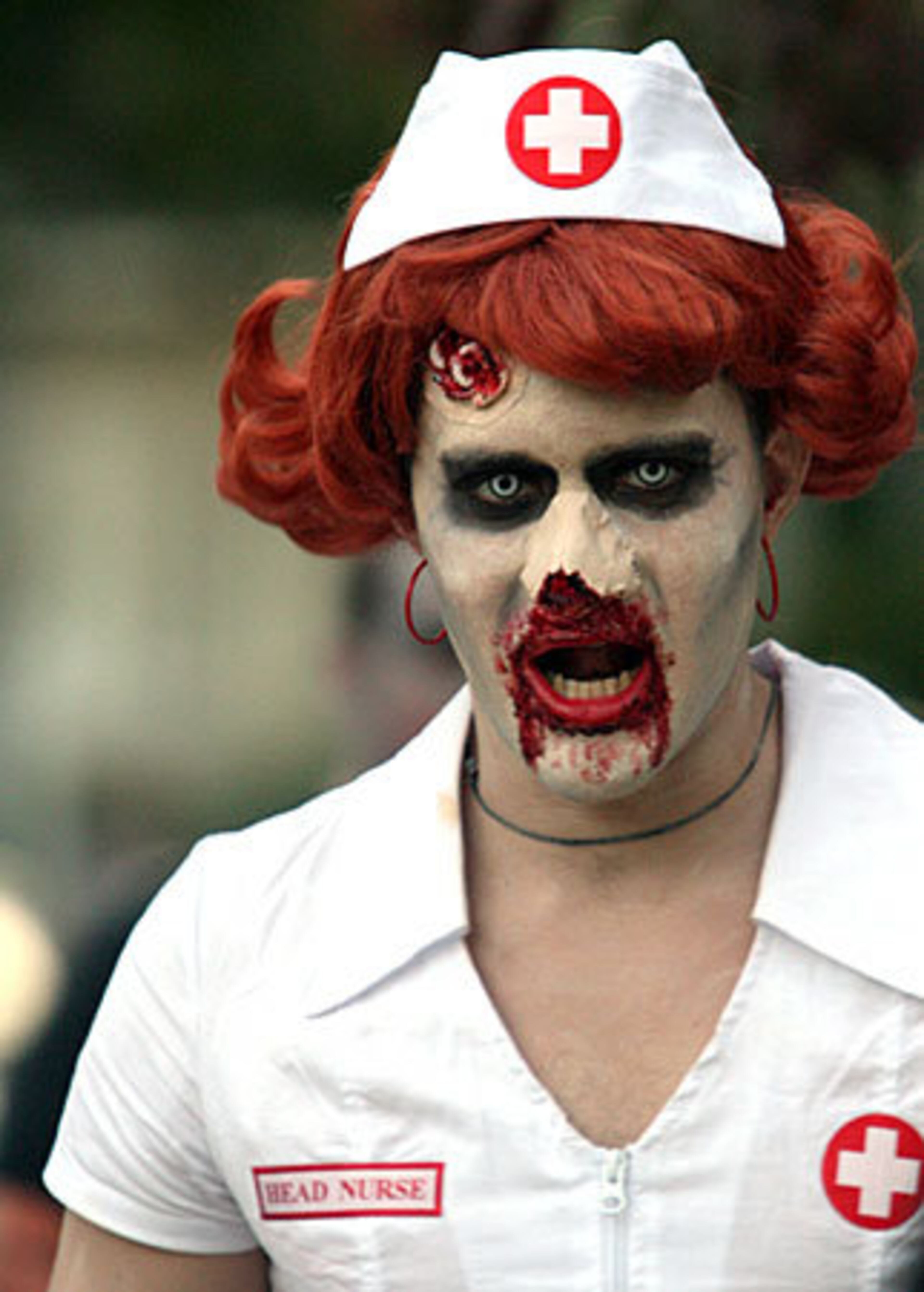 Matt Smith, dressed as a zombie head nurse, walks with over 300 people participating in the Zombie Walk.