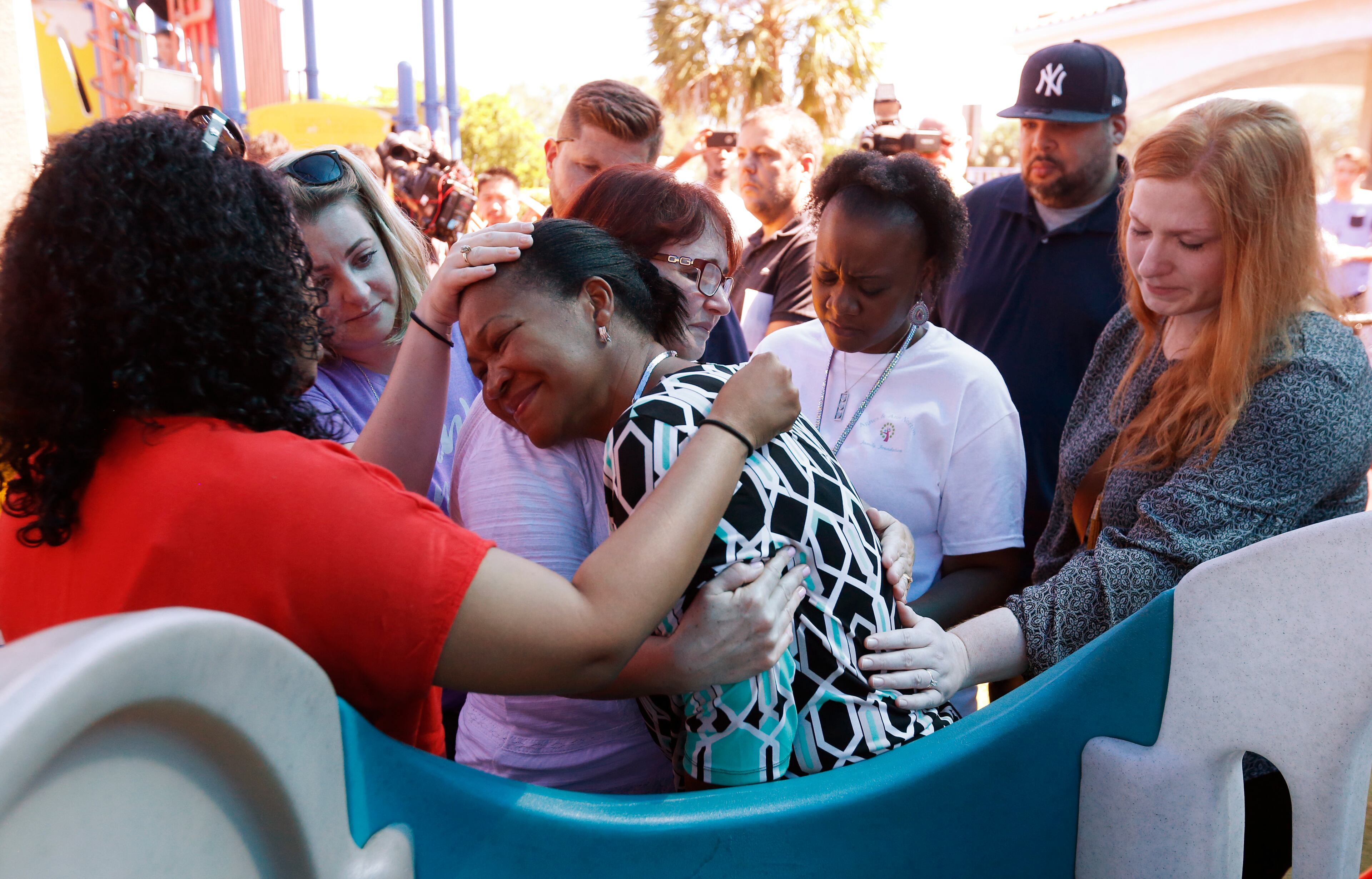 Attendees comfort each other at a prayer vigil for the victims of the shooting at Marjory Stoneman Douglas High School at the Parkland Baptist Church, Thursday, Feb. 15, 2018 in Parkland, Fla. Nikolas Cruz, a former student, was charged with 17 counts of premeditated murder Thursday morning. (AP Photo/Wilfredo Lee)
