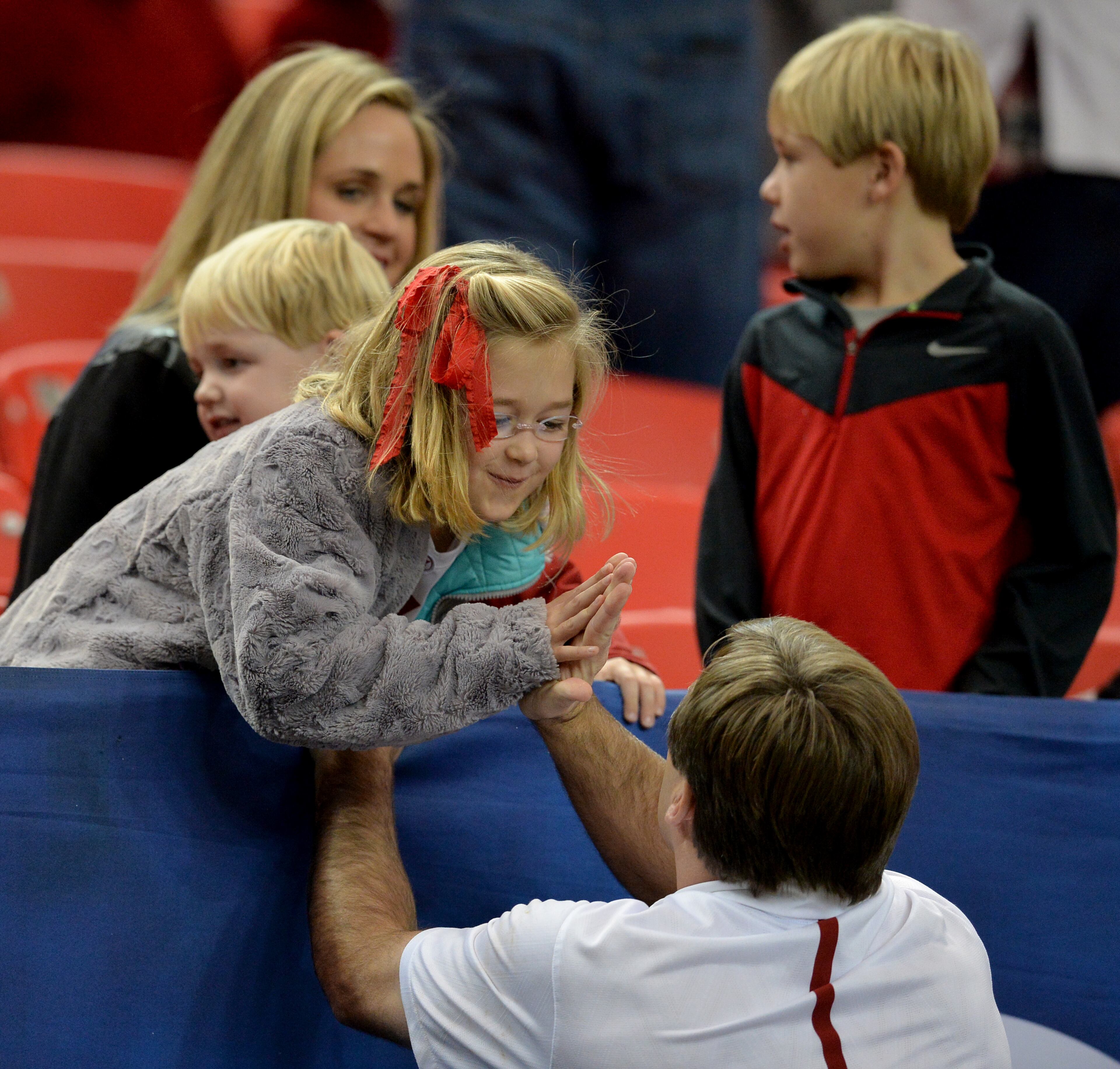 Alabama Crimson Tide defensive coordinator and soon to be Georgia coach, Kirby Smart gets a high five from his daughter Julia before the teams took the field to arm-up for the SEC Championship at the Georgia Dome Saturday December 5, 2015. BRANT SANDERLIN/BSANDERLIN@AJC.COM