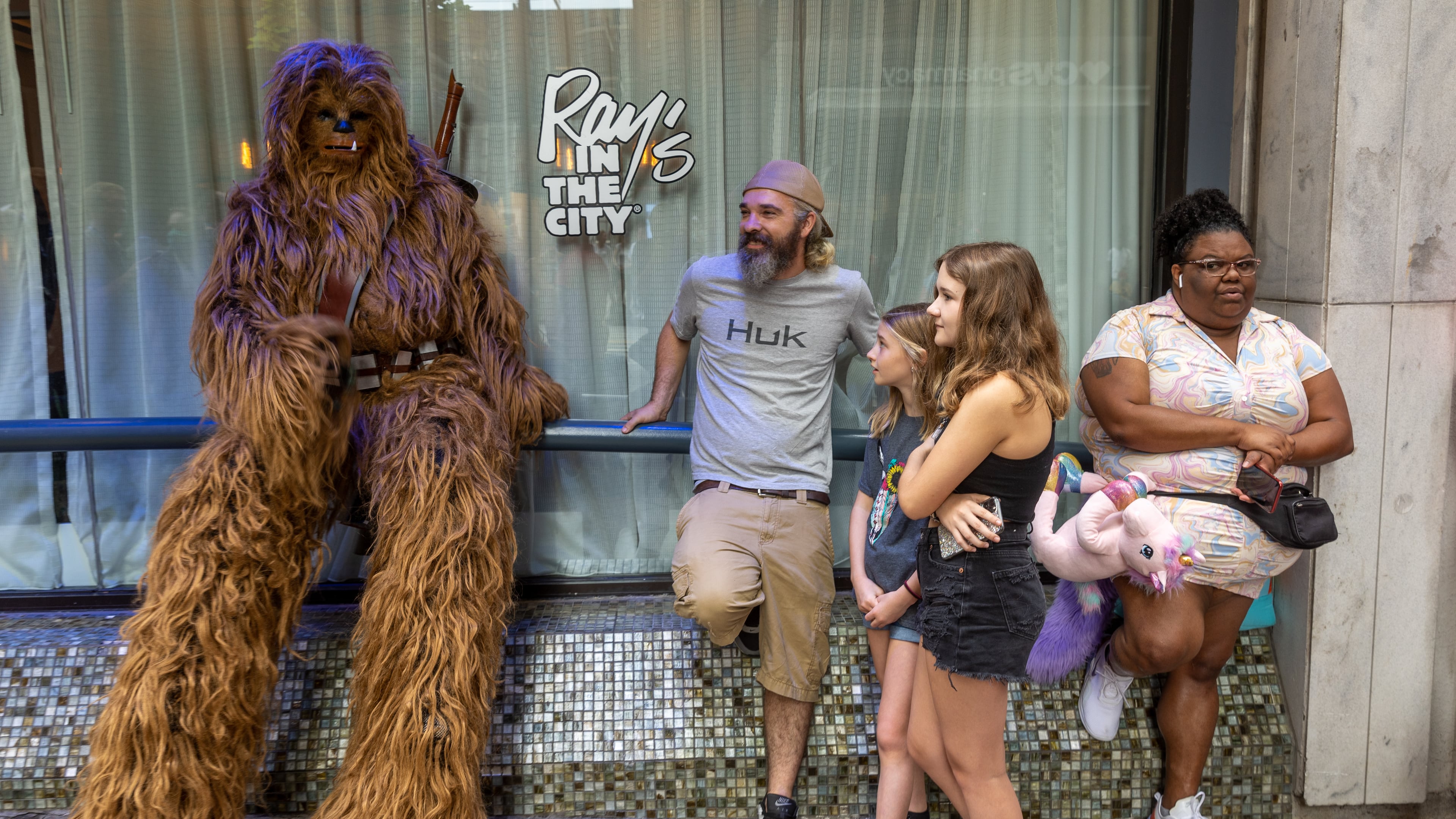People hang out on Peachtree St, waiting for the Dragon Con Parade to start Saturday, Sep. 3, 2022. Steve Schaefer/steve.schaefer@ajc.com)