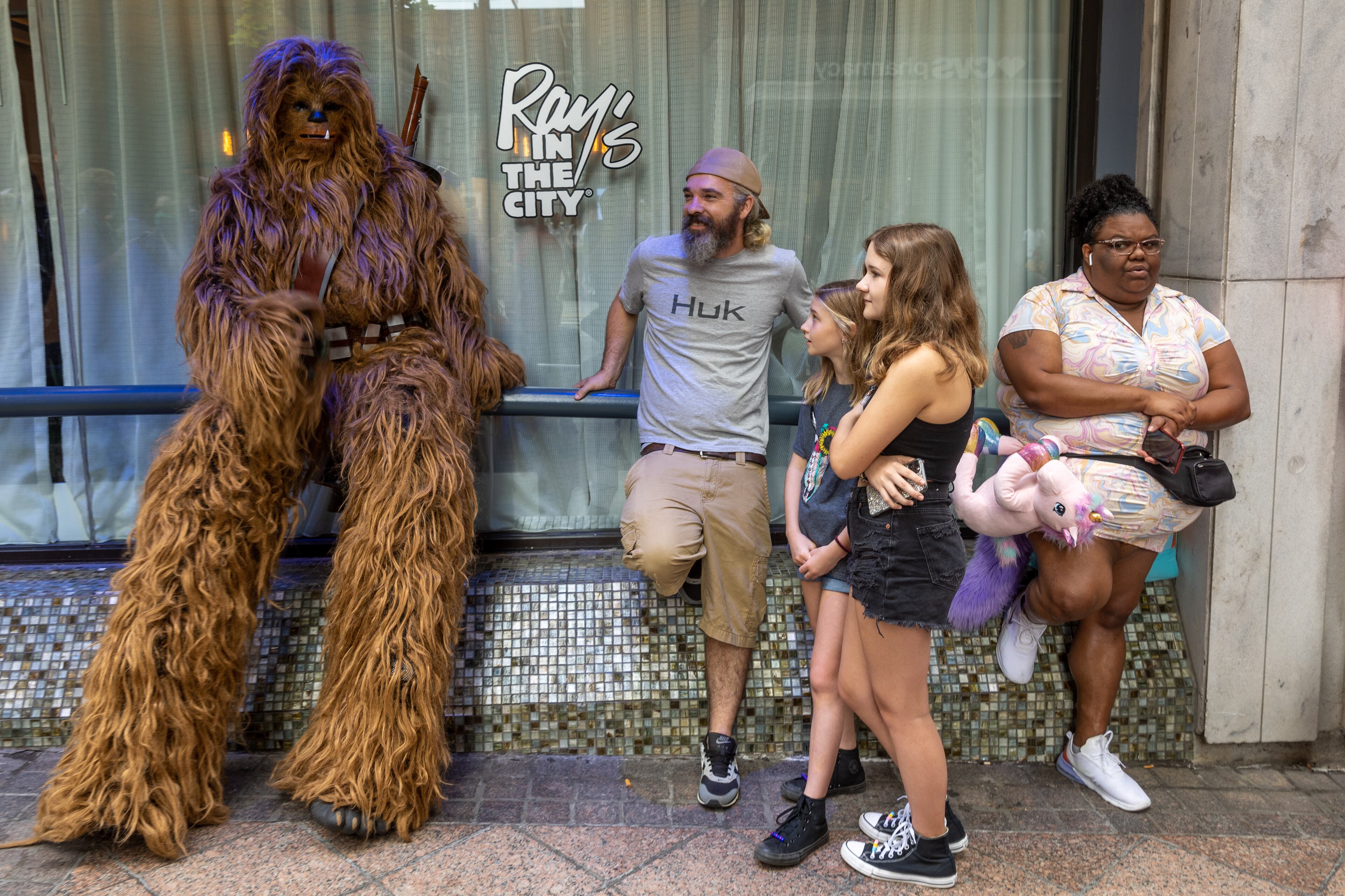 People hang out on Peachtree Street in Atlanta while waiting for the Dragon Con Parade to start Saturday, Sept. 3, 2022. (Photo: Steve Schaefer/steve.schaefer@ajc.com)