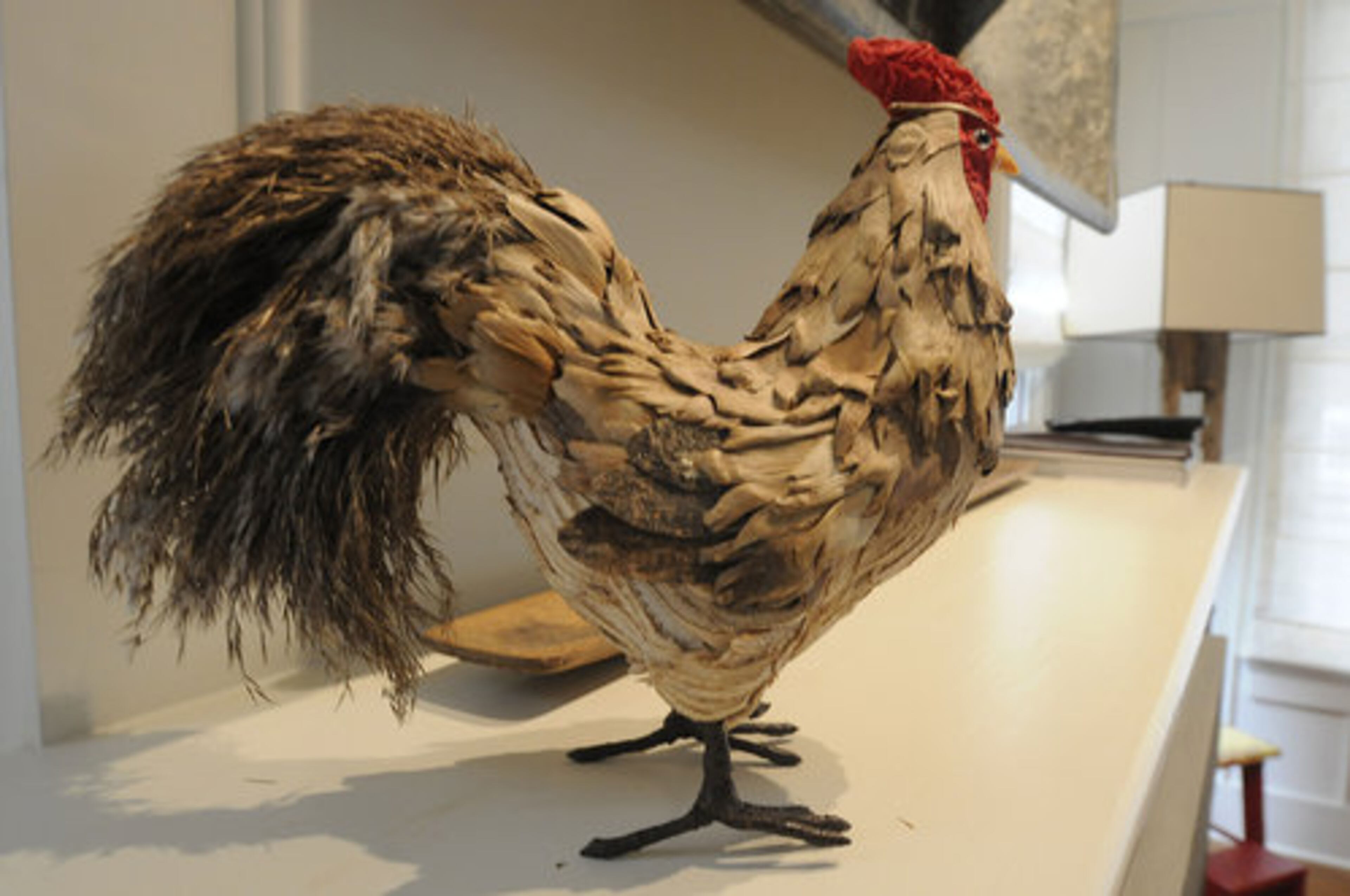 This rooster sculpture stands alert on a shelf in Susan Isakson's Serenbe home, adding a whimsical touch.