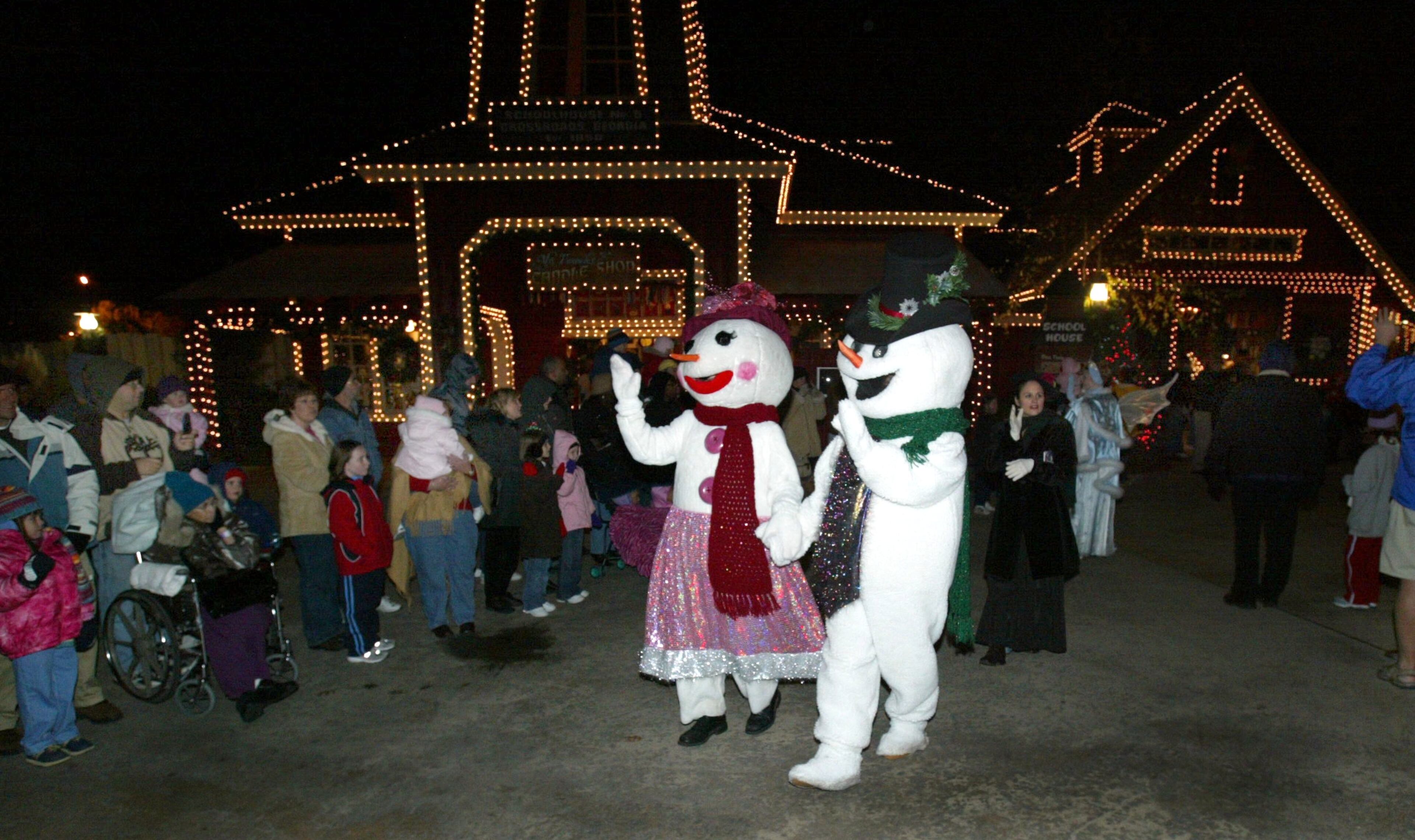 Snow couple in the parade through Cross Roads as part of Santa's grand entrance at Stone Mountain Park.