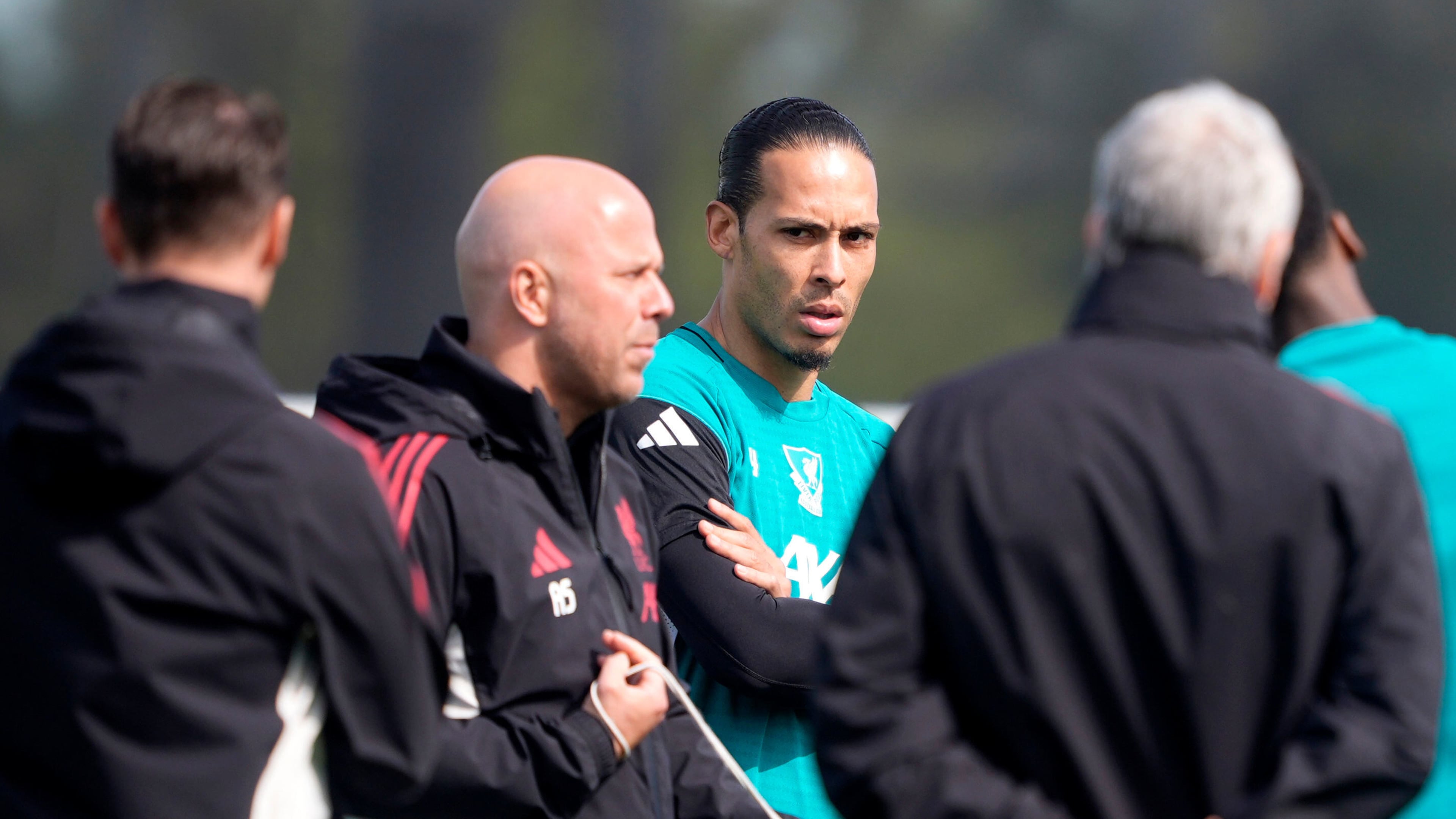 Liverpool's Virgil van Dijk, center, and manager Arne Slot, second left, attend a training session in Liverpool, England, Tuesday April 7, 2026. (Peter Byrne/PA via AP)