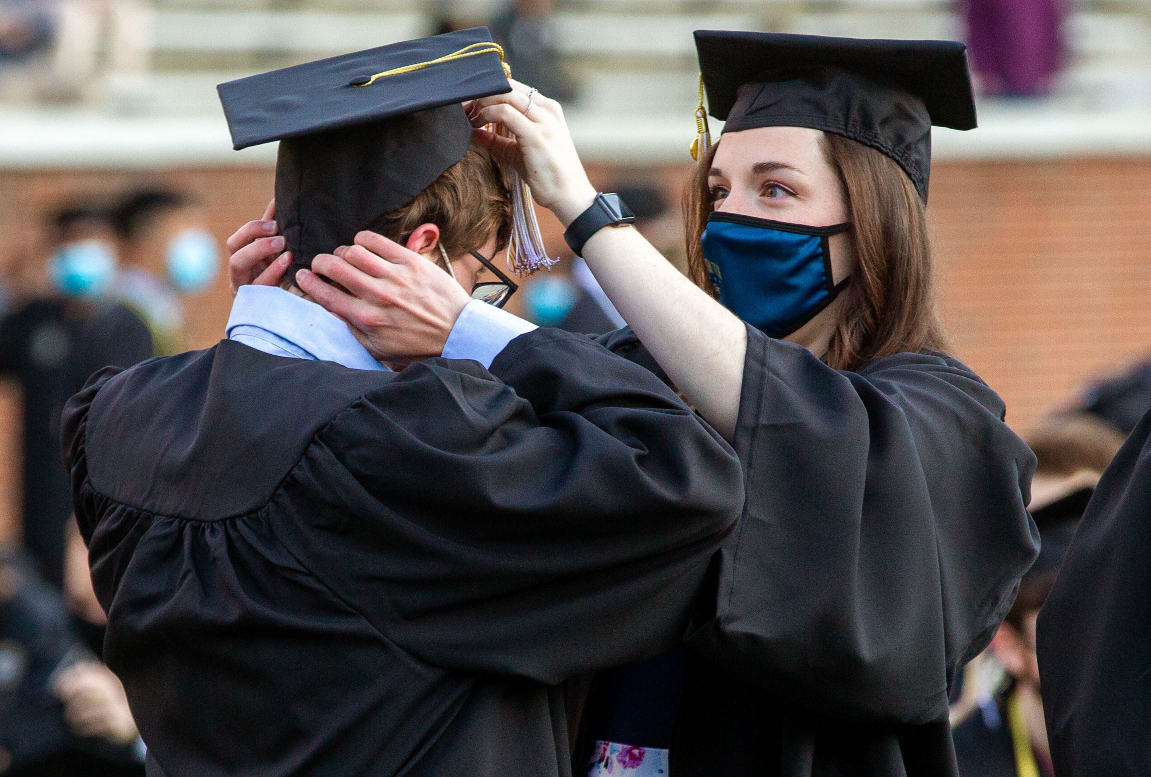 Margaret Berry (right) helps Andrew Dallas get ready before the start of the Georgia Tech 2021 commencement ceremony in Bobby Dodd Stadium on Saturday, May 8, 2021. Two ceremonies were held Saturday for bachelor’s degree recipients, and master's and doctoral graduates' ceremonies were held Friday. (Photo: Steve Schaefer for The Atlanta Journal-Constitution)