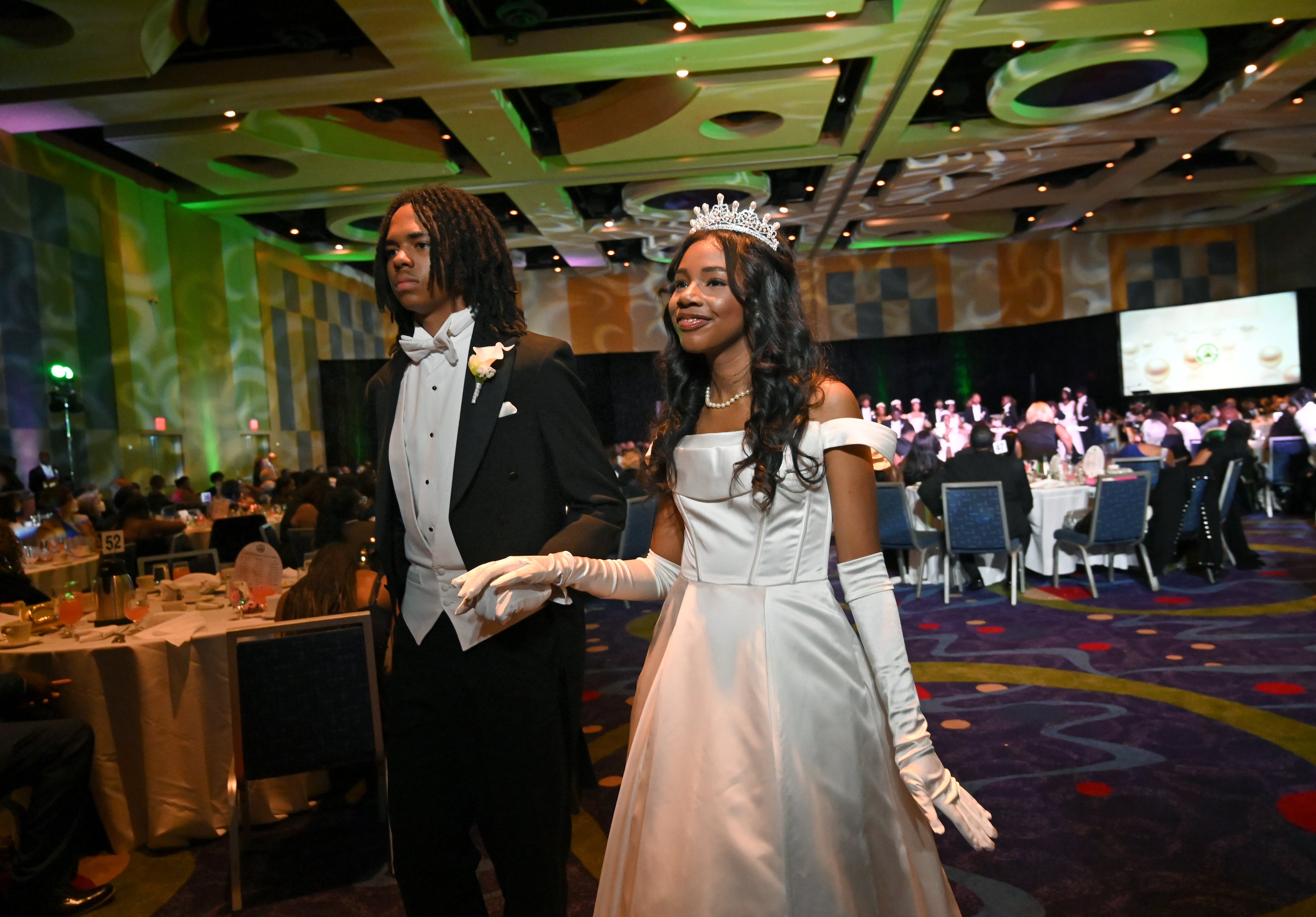 Debutante Yolanda Renee King is escorted by junior escort Brandon Coleman during 2026 Pink Cultured Pearls Cotillion. (Hyosub Shin/AJC)