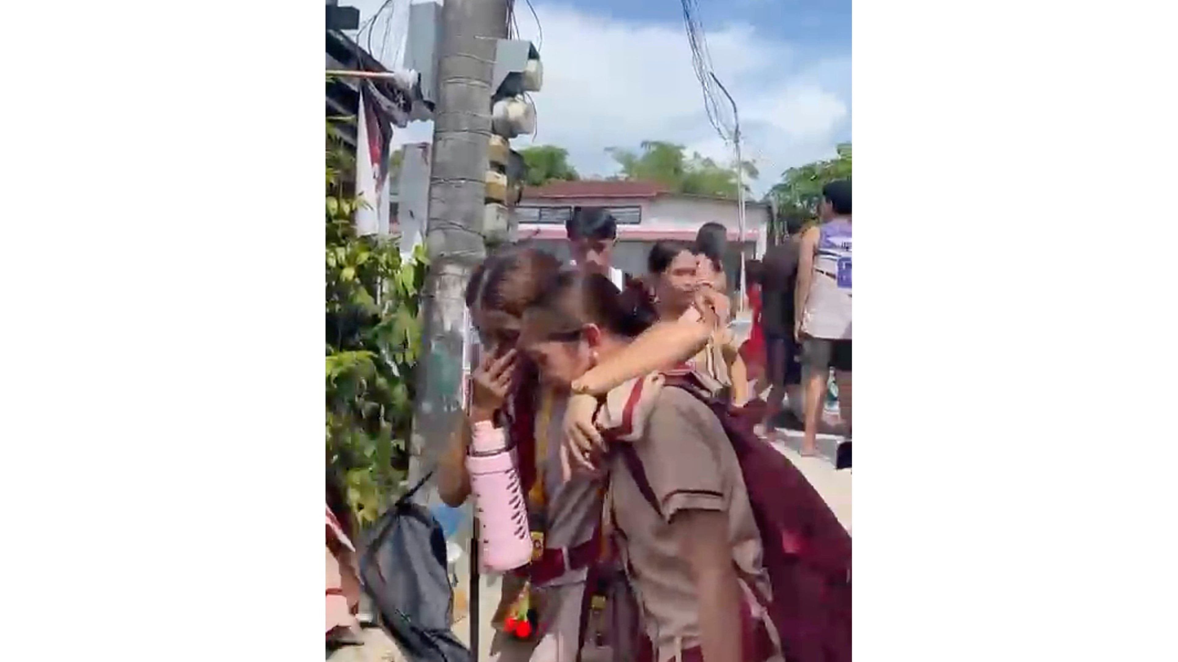 In this photo taken from a video, students react after a shooting incident at the San Jose National High School in Tacloban city, Philippines Monday, June 22, 2026. (James Daantos via AP Photo)
