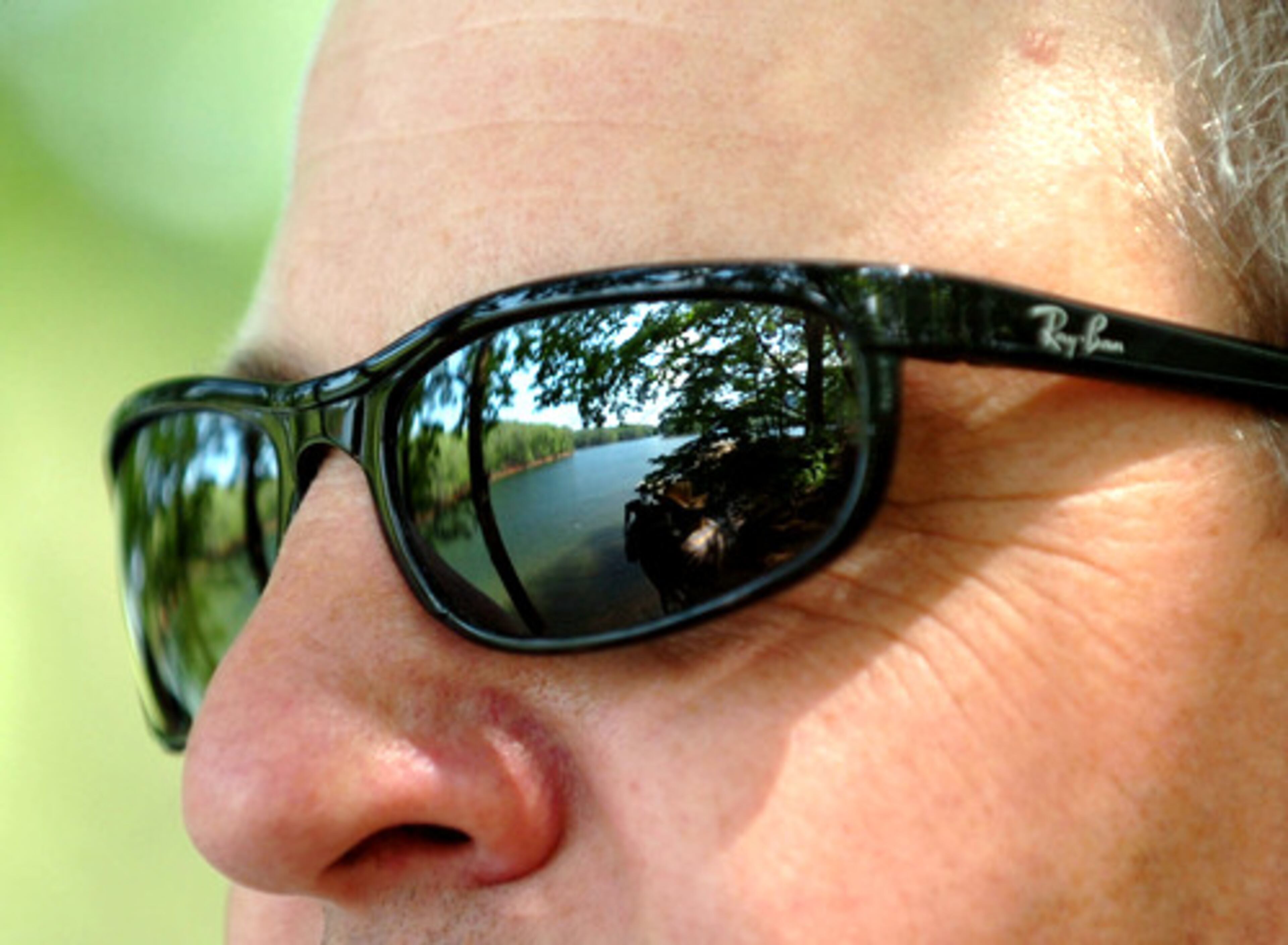 Lake Allatoona where two teens drowned today reflected in the sunglasses of James Hamilton, a regional manager with Georgia State Parks and Lodges. While swimming is allowed in almost all areas of Lake Allatoona, it is not recommended in the isolated cove where the boys were swimming, he said.