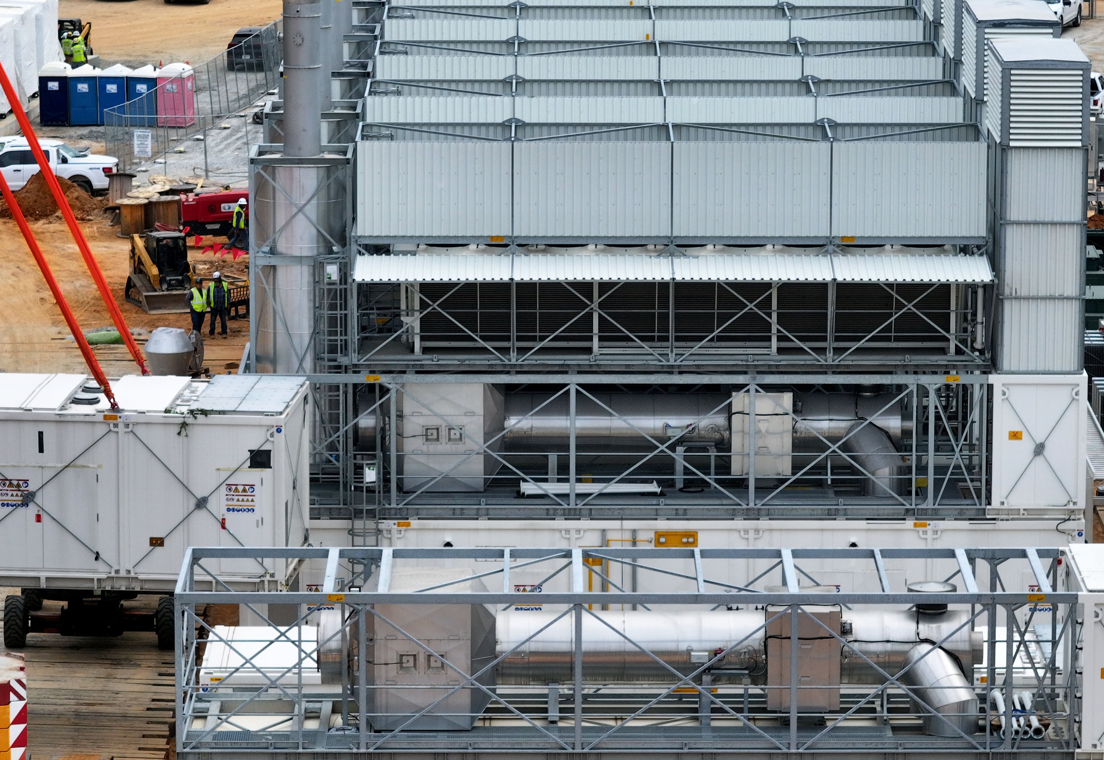 An aerial view shows off-grid generators being installed by a company called VoltaGrid on land next door to a data center on Thursday, June 25, 2026, in Covington. (Hyosub Shin/AJC)