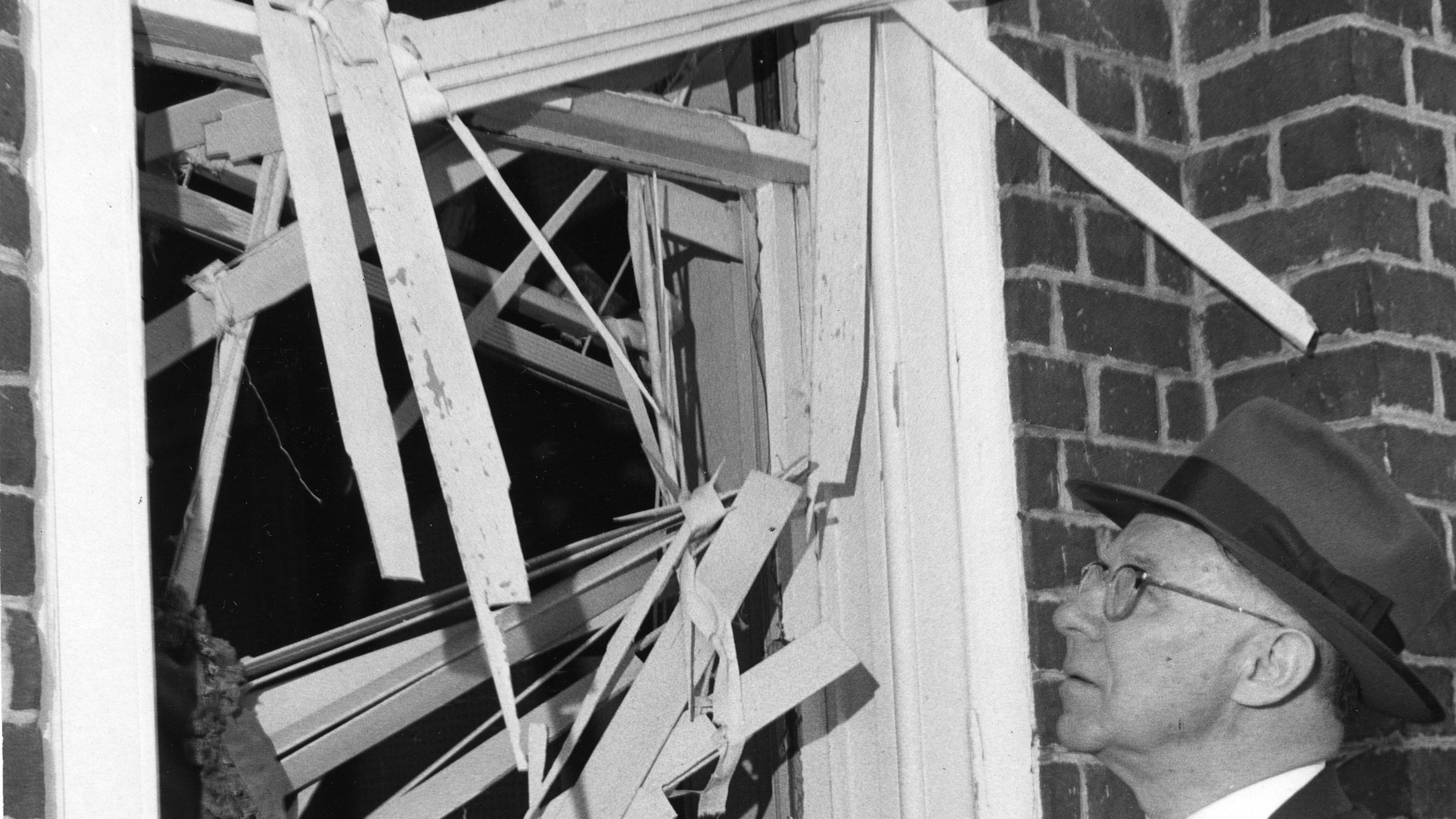 Mayor Hartsfield examines the damage done to a window as a result of the Hebrew Benevolent Congregation bombing in Atlanta, October 1958. What came to be known as the "Temple bombing" was an attack by white supremacists on the Temple, which had been a center for civil rights advocacy during the '50s. Nobody was injured in the blast.