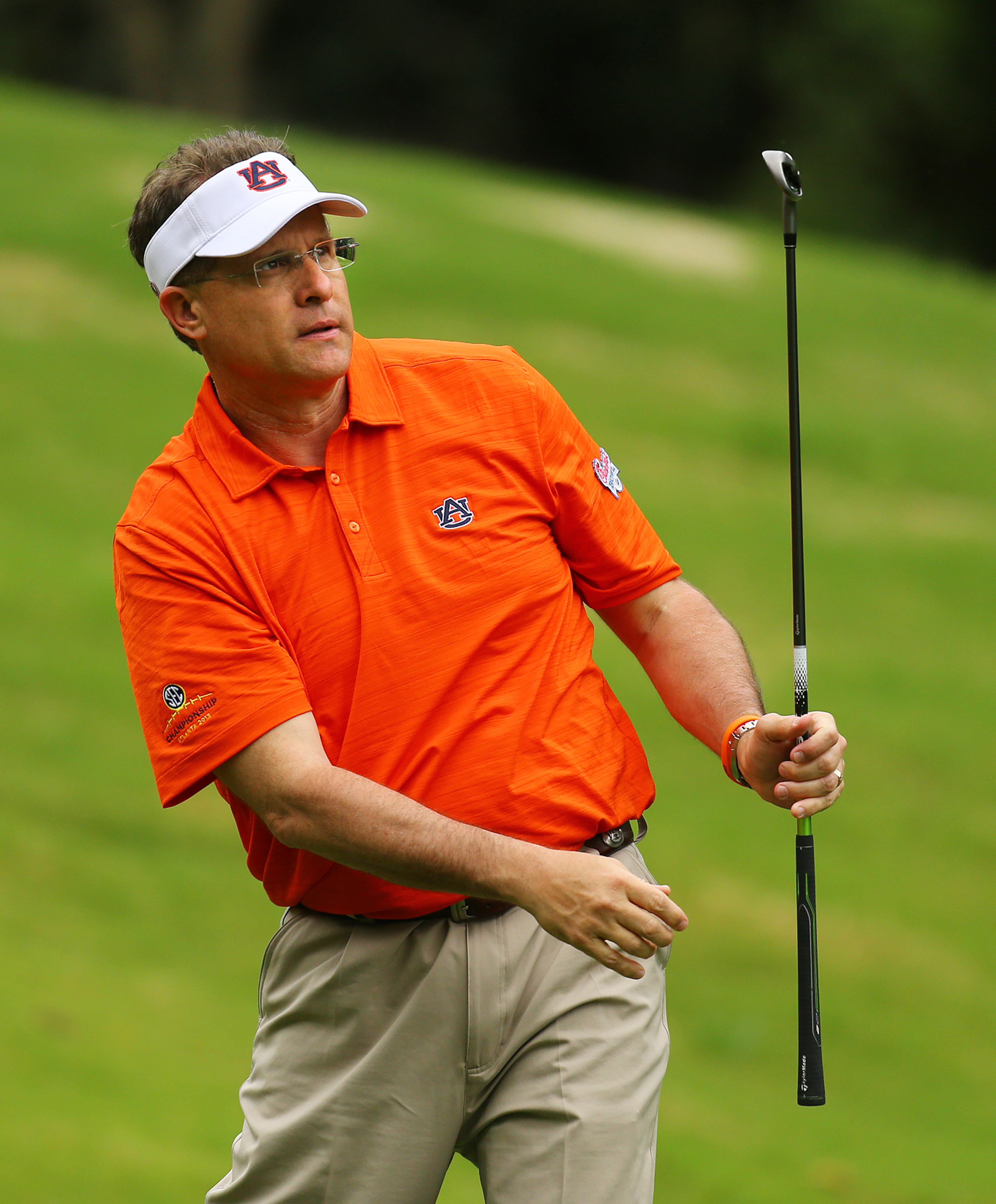 Auburn head football coach Gus Malzahn watches his tee shot to the No. 8 hole during the Chick-fil-A Bowl Challenge featuring an 11 team field of NCAA head coaches and celebrity alumni at Reynolds Plantation on Tuesday, April 29, 2014, in Greensboro. Teams compete for a share of the $520,000 scholarship purse for their universities. CURTIS COMPTON / CCOMPTON@AJC.COM
