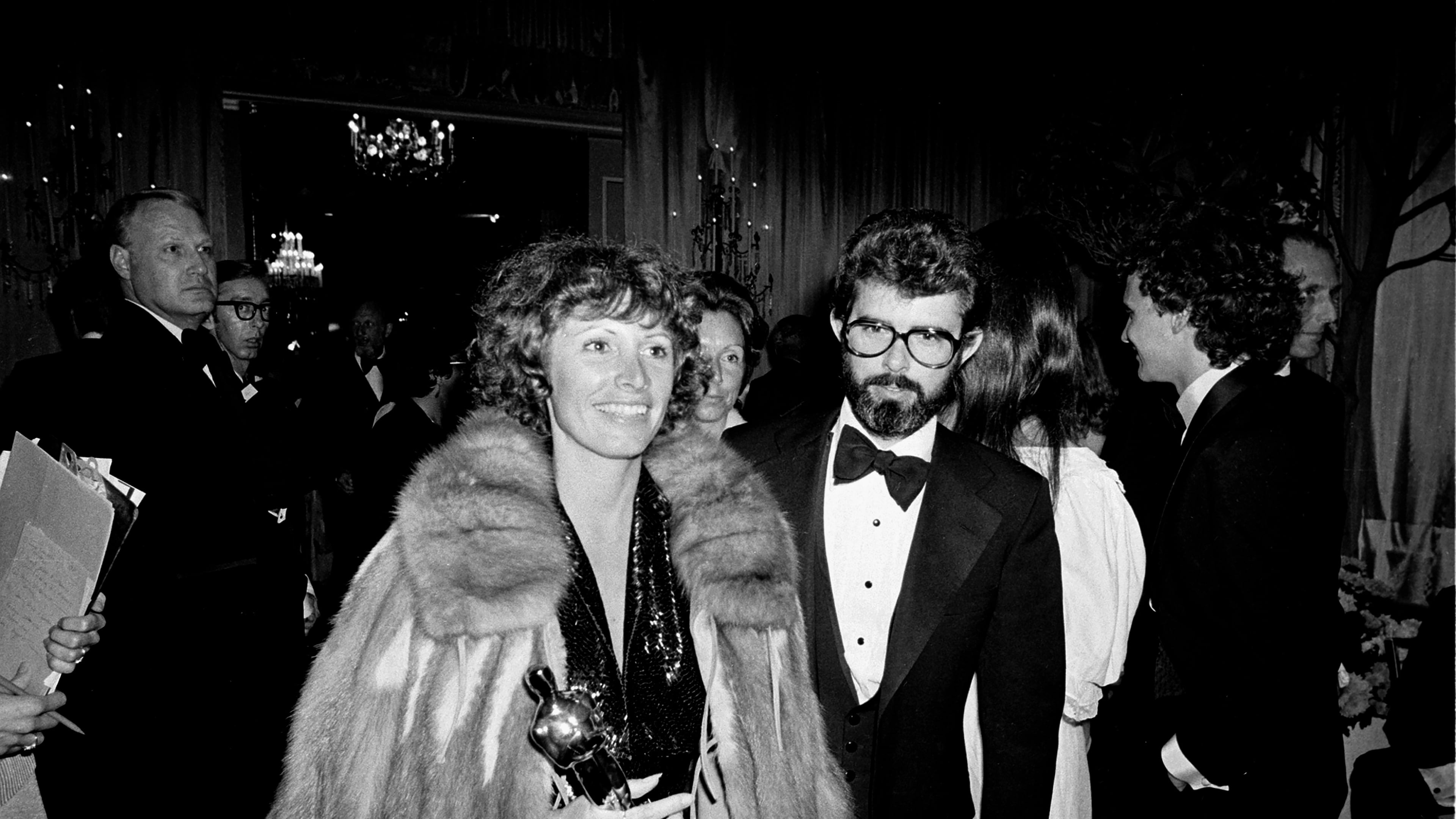 FILE - Marcia Lucas, wife of director George Lucas, right, carries her Oscar statuette as they arrive at a post Academy Awards party at the Beverly Hilton Hotel in Los Angeles, April 4, 1978. (AP Photo, File)