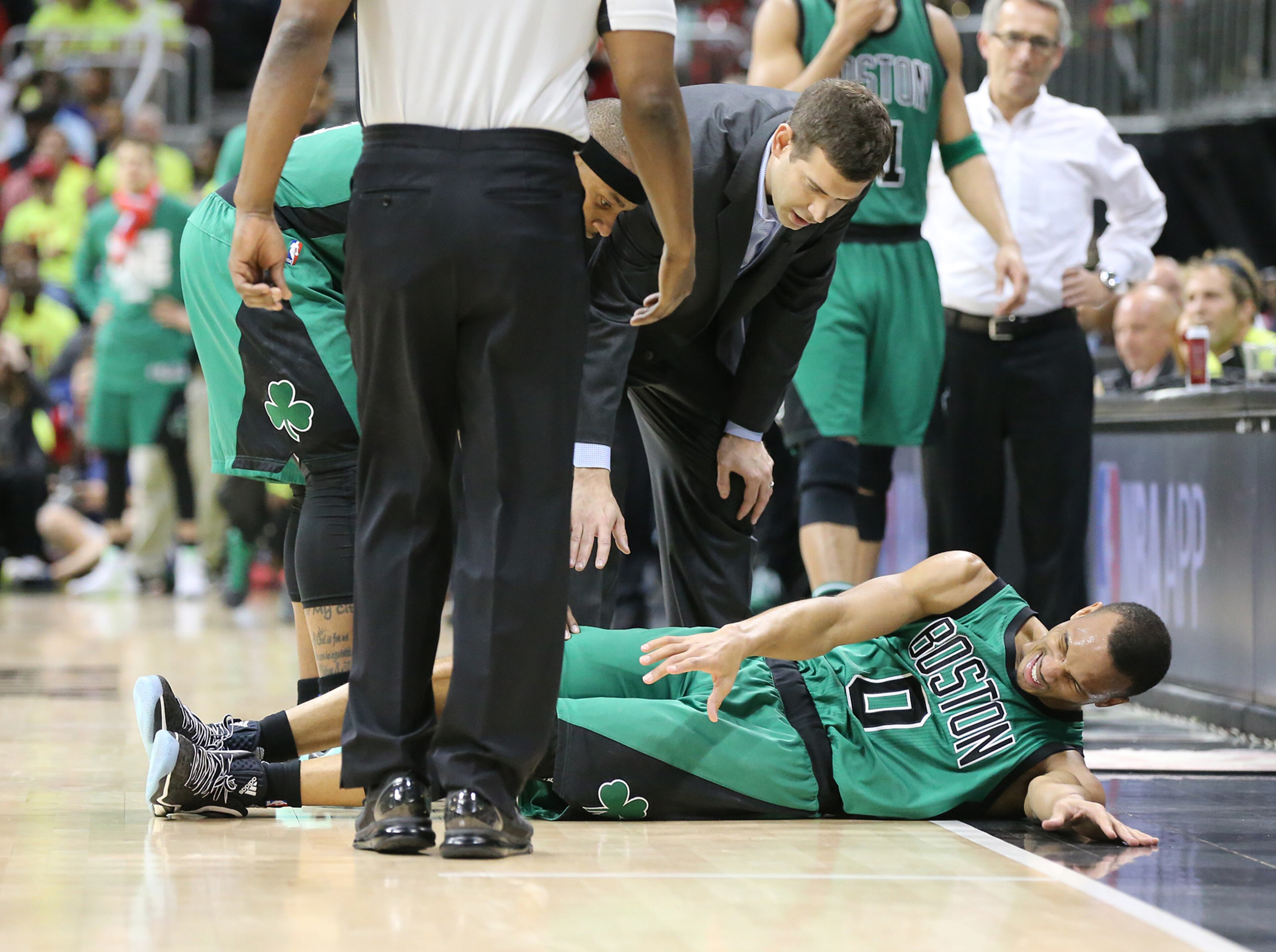 041616 ATLANTA: Celtics guard Avery Bradley goes down on the hardwood and leaves the game against the Hawks in game one of their NBA Eastern Conference first round playoff game at Philips Arena on Saturday, April 16, 2016. Curtis Compton / ccompton@ajc.com