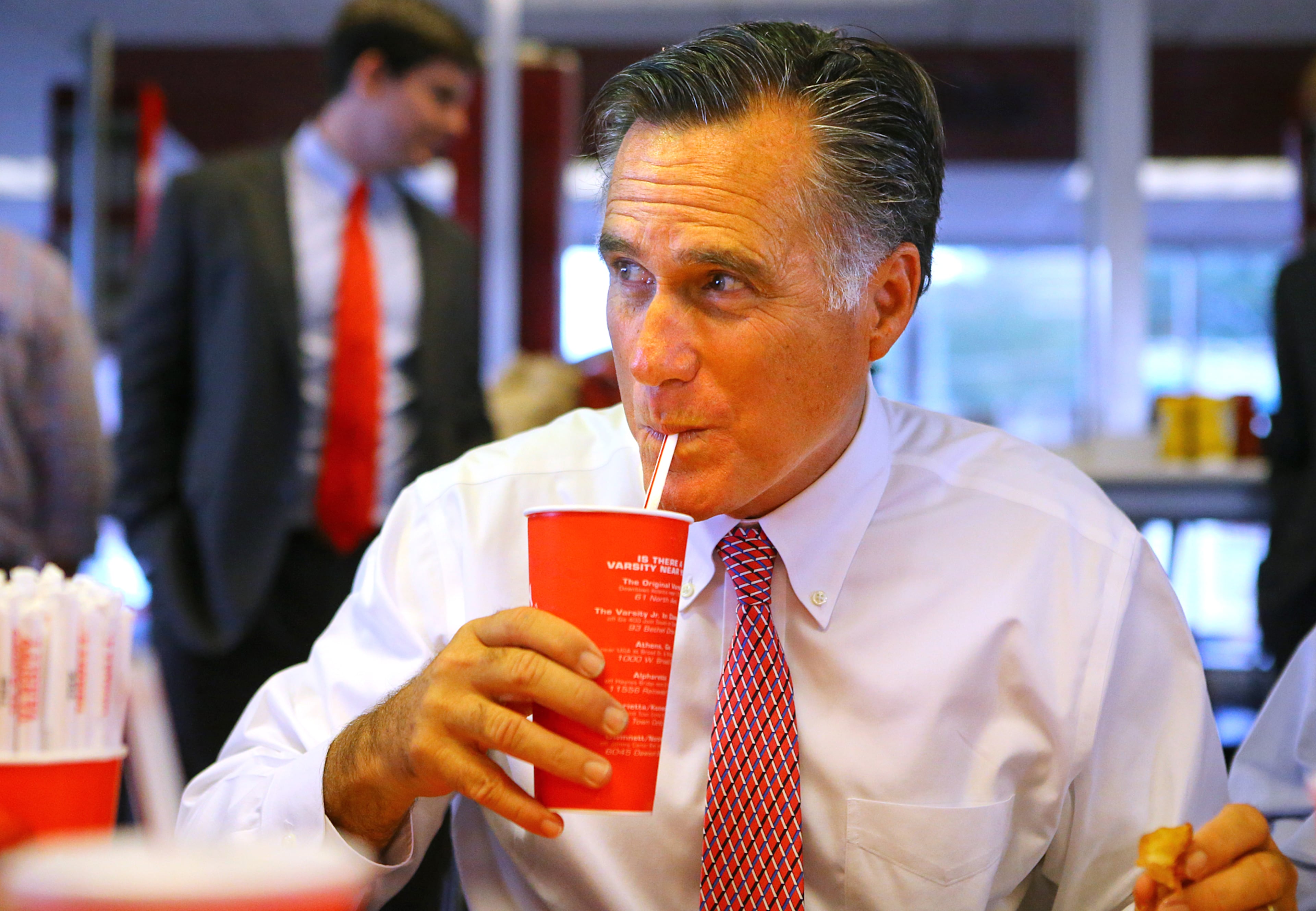 100114 ATLANTA: Former presidential hopeful Mitt Romney enjoys a iconic frosted orange while stumping in Georgia for Attorney General Sam Olens, joining Olens for lunch at The Varsity on Wednesday, Oct. 1, 2014, in Atlanta. CURTIS COMPTON / CCOMPTON@AJC.COM