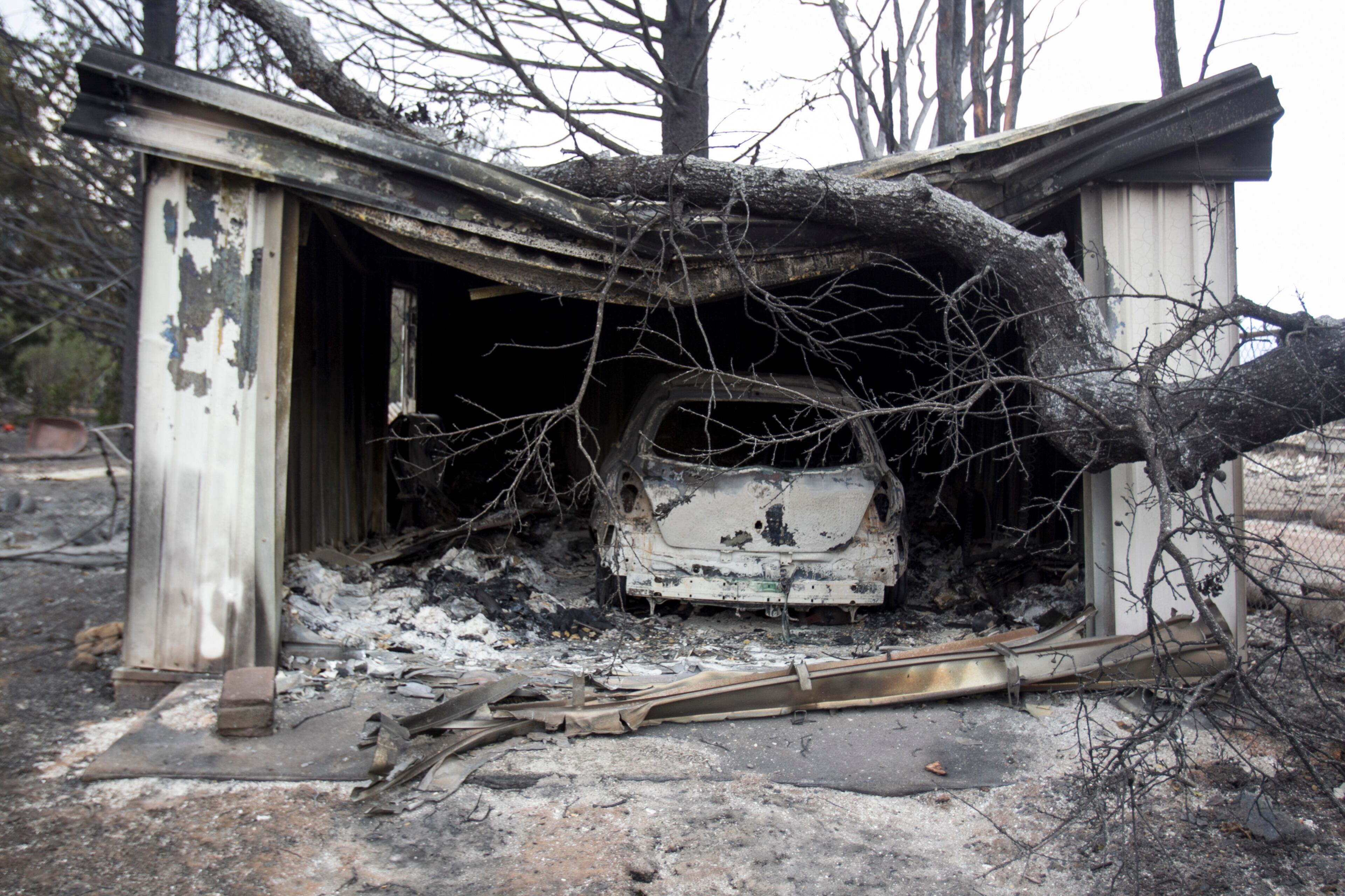 A car remains in a garage that was destroyed by a wildfire in Middletown, Calif., Sept. 14, 2015. Despite the efforts of thousands of firefighters, three major fires have consumed 270,000 acres, forcing the evacuation of thousands of people, state officials said. (Ilana Panich-Linsman/The New York Times)