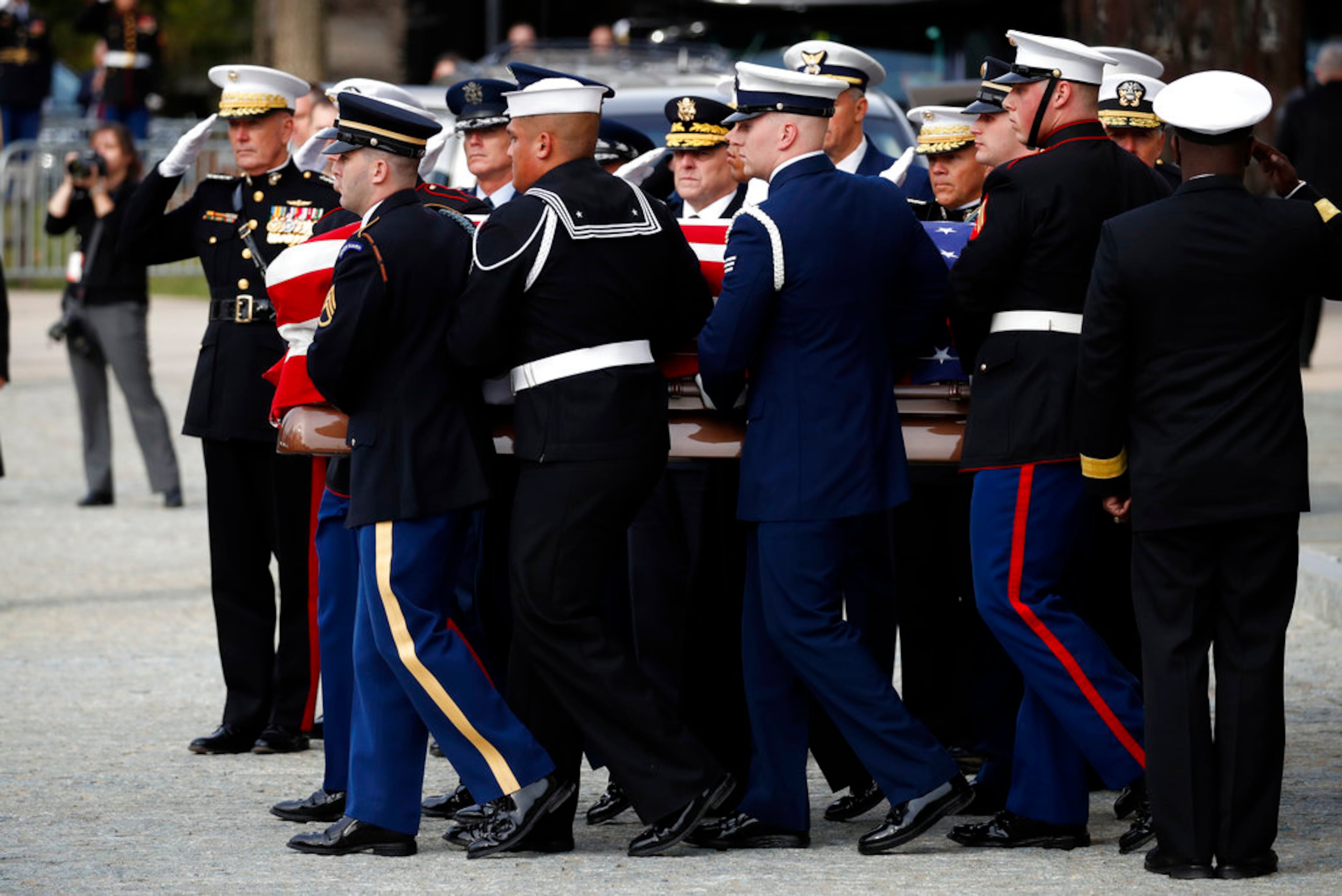 The flag-draped casket of former President George H.W. Bush is carried by a joint services military honor guard after a State Funeral at the National Cathedral, Wednesday, Dec. 5, 2018, in Washington. (AP Photo/Alex Brandon, Pool)