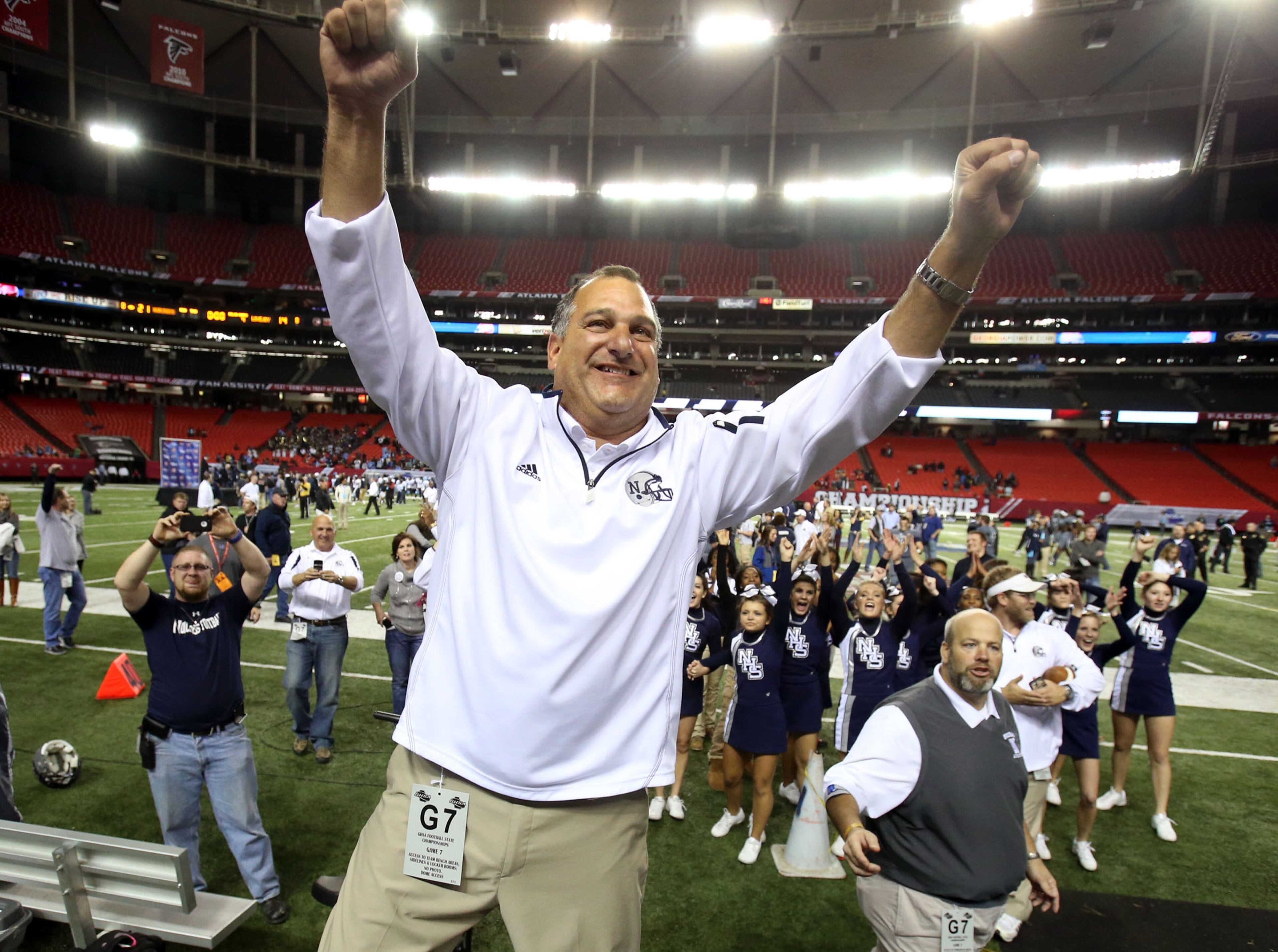 Maloof stands on a bench and celebrates with Norcross fans.
