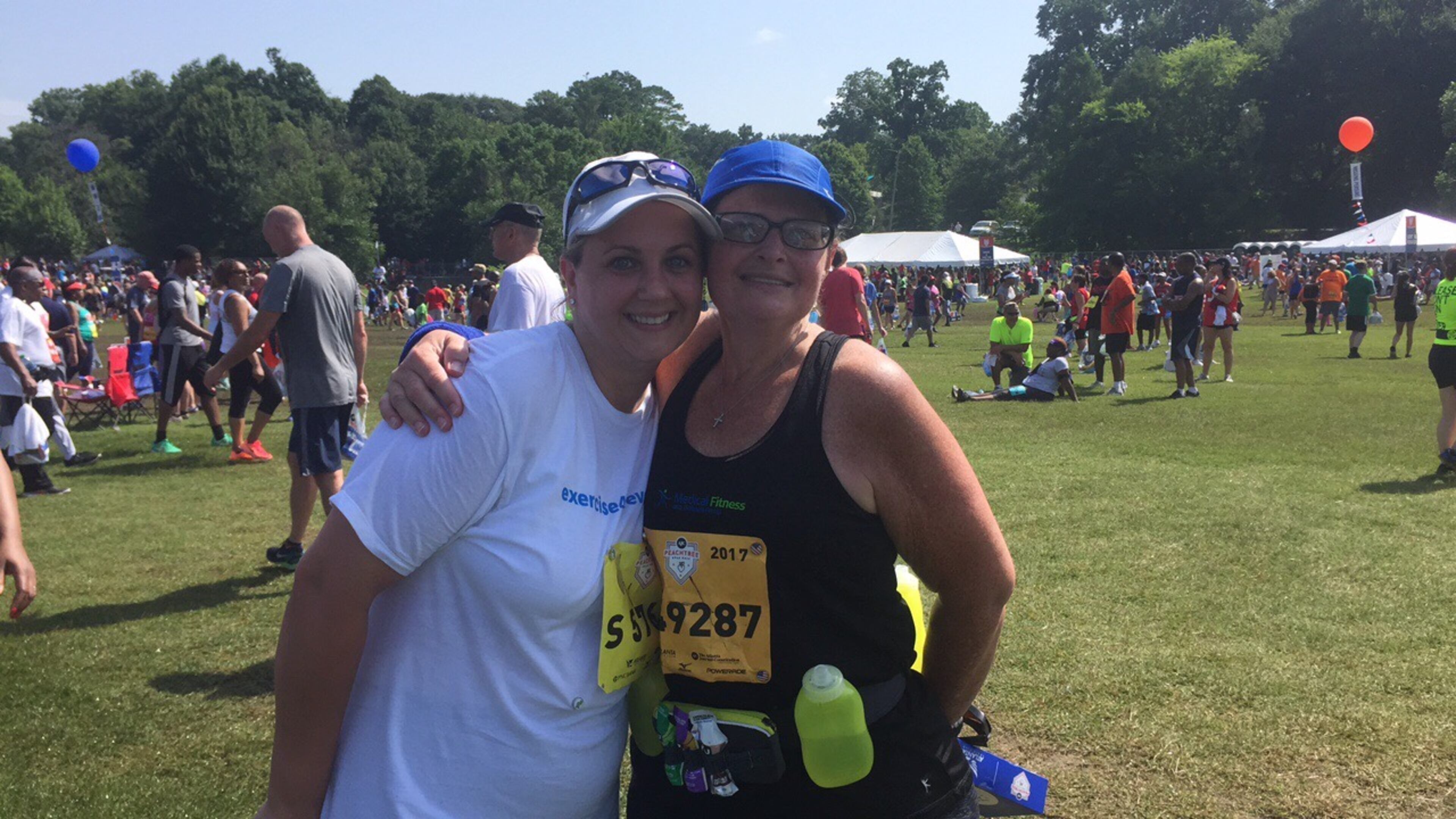 Kimberly Flowers, right, and Heni Jordan, left, completed the AJC Peachtree Road Race on Tuesday morning. Flowers has lost 113 pounds in the last 16 months.