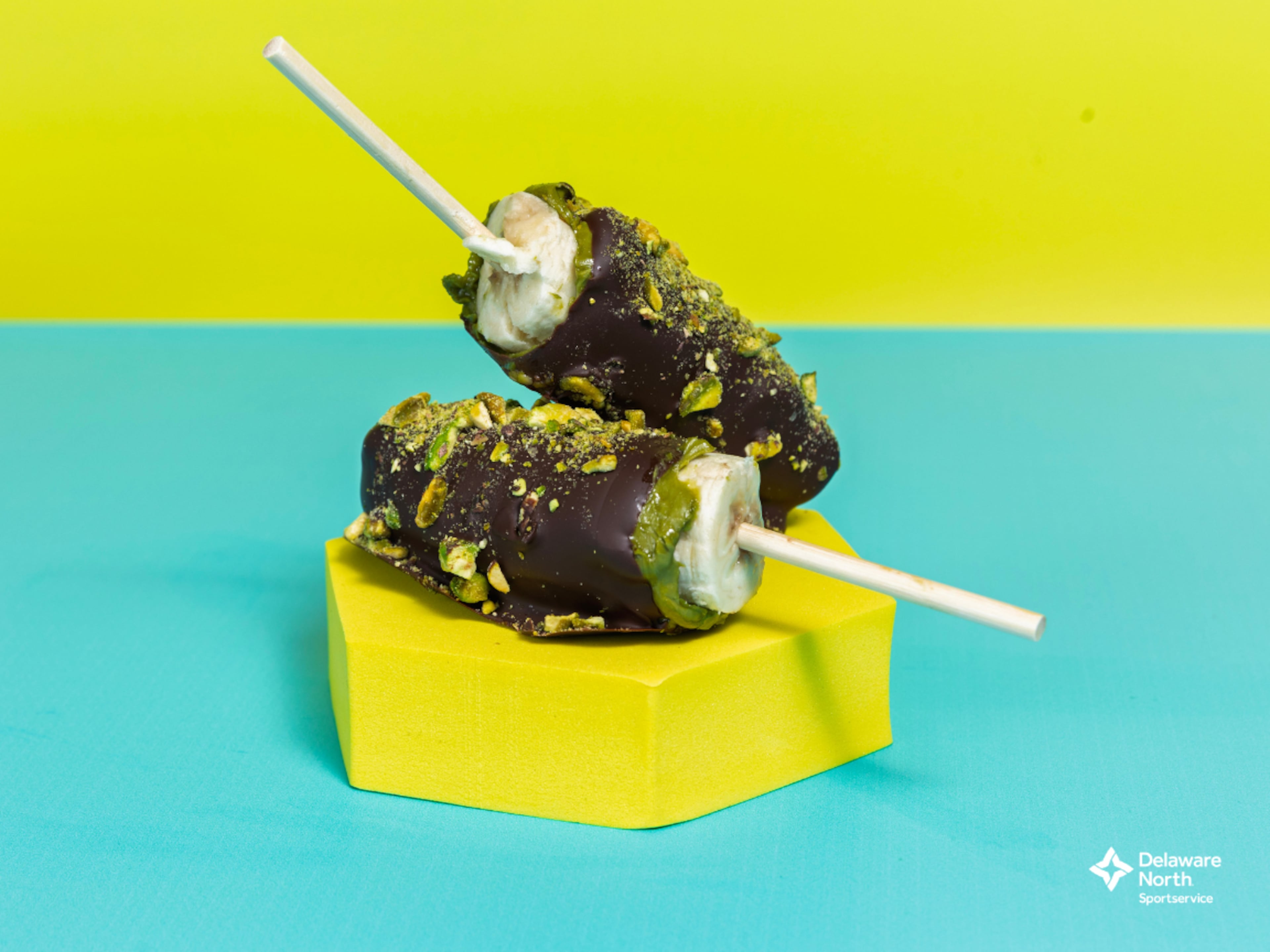 The Banana Royale: A Banana Ball take on Dubai chocolate. A frozen banana dipped in rich pistachio cream, coated with a chocolate shell and finished with crunchy pistachio pieces. (Courtesy of Delaware North)