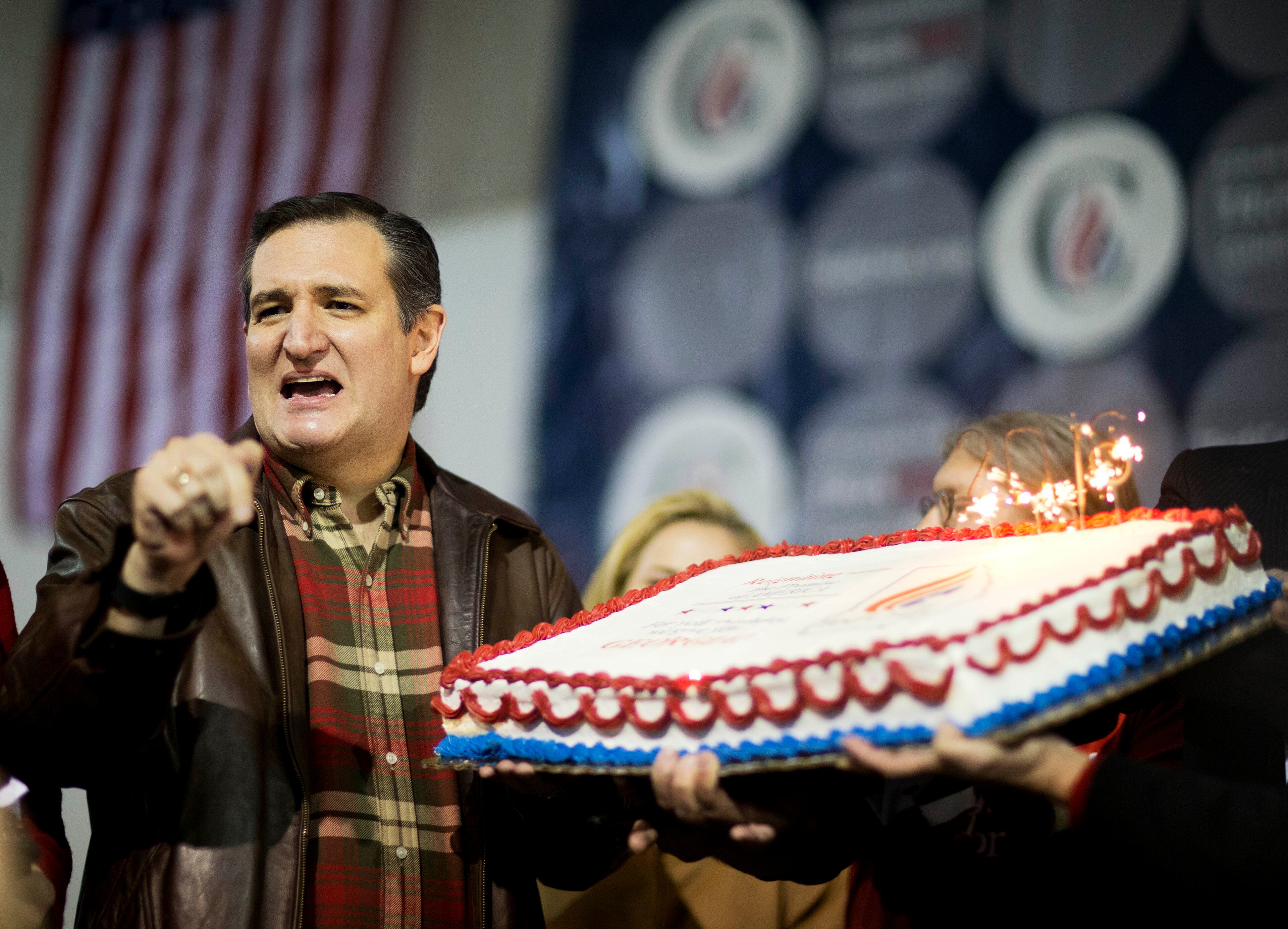 Republican presidential candidate, Sen. Ted Cruz, R-Texas, is presented with a birthday cake ahead of his upcoming birthday Tuesday during a campaign event in an airport hanger Friday, Dec. 18, 2015, in Kennesaw, Ga. (AP Photo/David Goldman)