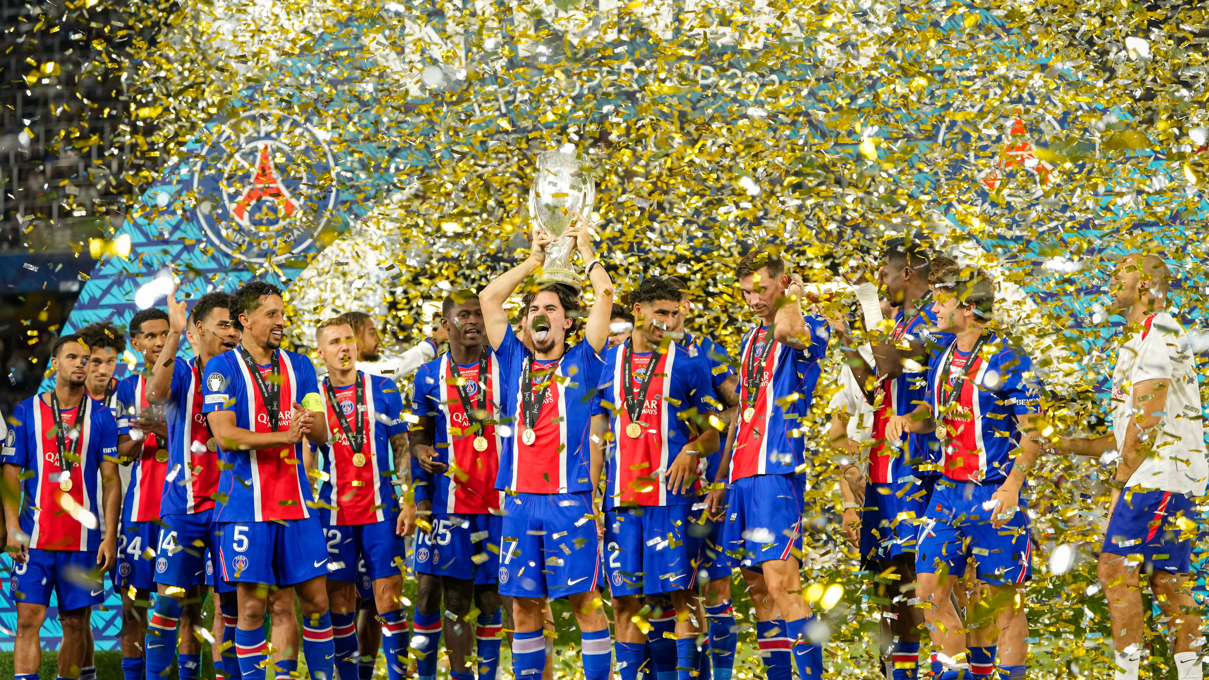 PSG's Vitinha lifts the trophy during celebrations at the end of the UEFA Super Cup soccer match between Paris Saint-Germain and Aston Villa in Salzburg, Austria, Wednesday, Aug.12, 2026. (AP Photo/Darko Bandic)