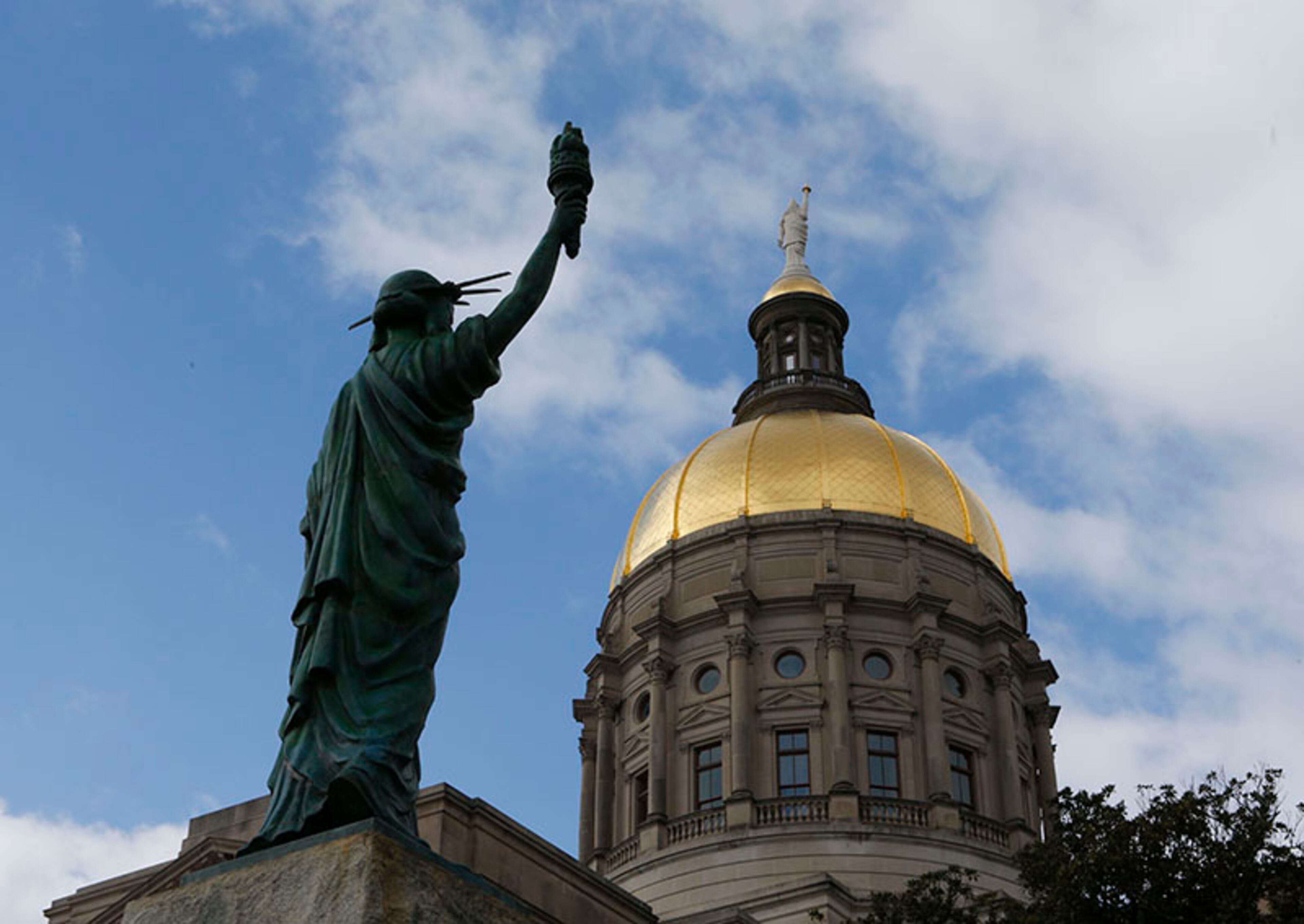 January 27, 2015 - Atlanta - The newly placed Statue of Liberty looks toward the Gold Dome. The statue was a gift from the Boy Scouts of America in the 1950's and is now located in Liberty Plaza across from the Capitol. Both the Senate and the House were in session today, With no bills ready for debate yet, both chambers focused on less serious matters. In the House, it was picture day (The Senate’s is Wednesday). The House and Senate each got a visit from representatives from the smokin’ hot Atlanta Hawks. BOB ANDRES / BANDRES@AJC.COM PHOTO BY BOB ANDRES / AJC