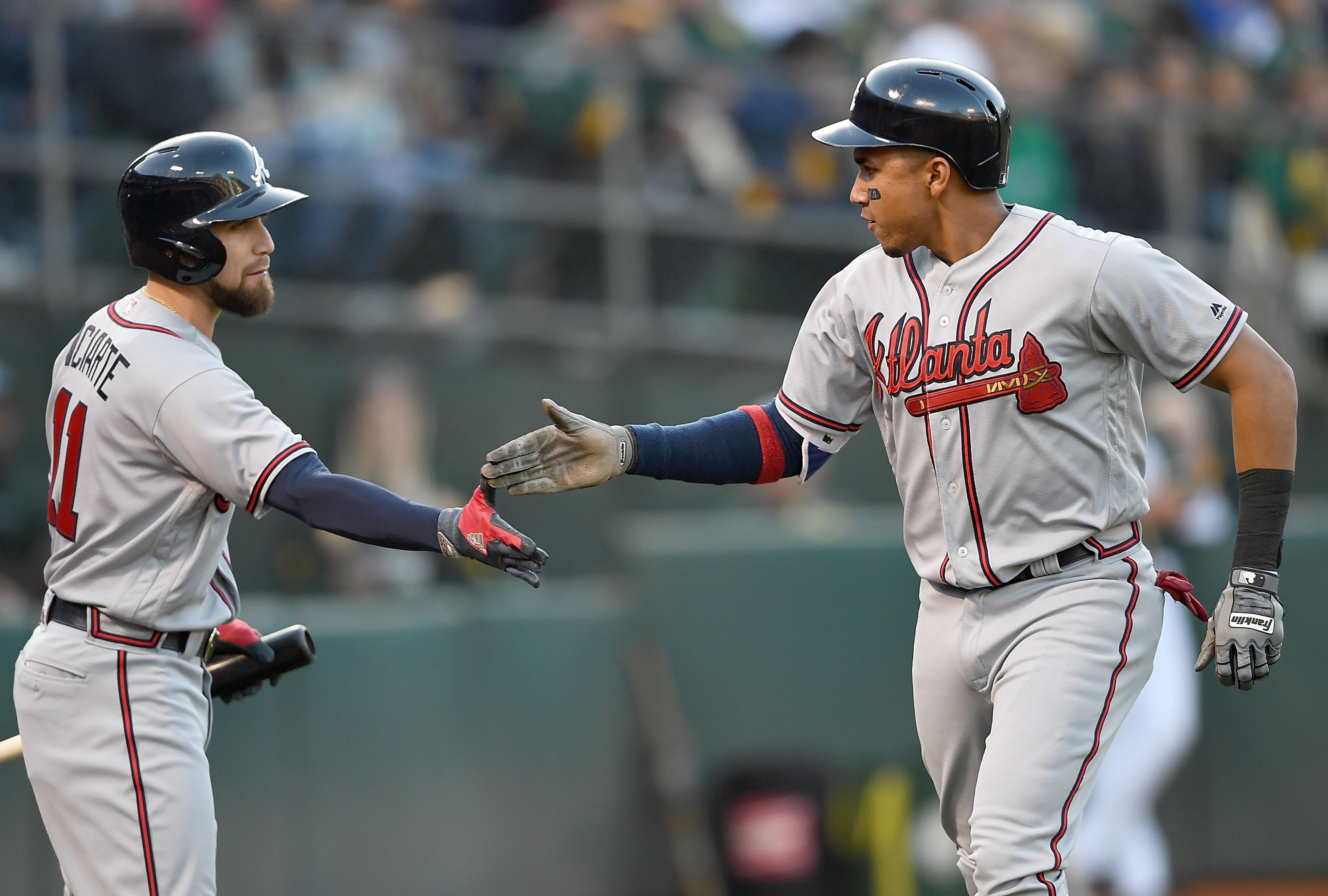OAKLAND, CA - JUNE 30: Johan Camargo #17 of the Atlanta Braves is congratulated byEnder Inciarte #11 after Camargo scored against the Oakland Athletics in the top of the third inning at Oakland Alameda Coliseum on June 30, 2017 in Oakland, California. (Photo by Thearon W. Henderson/Getty Images)