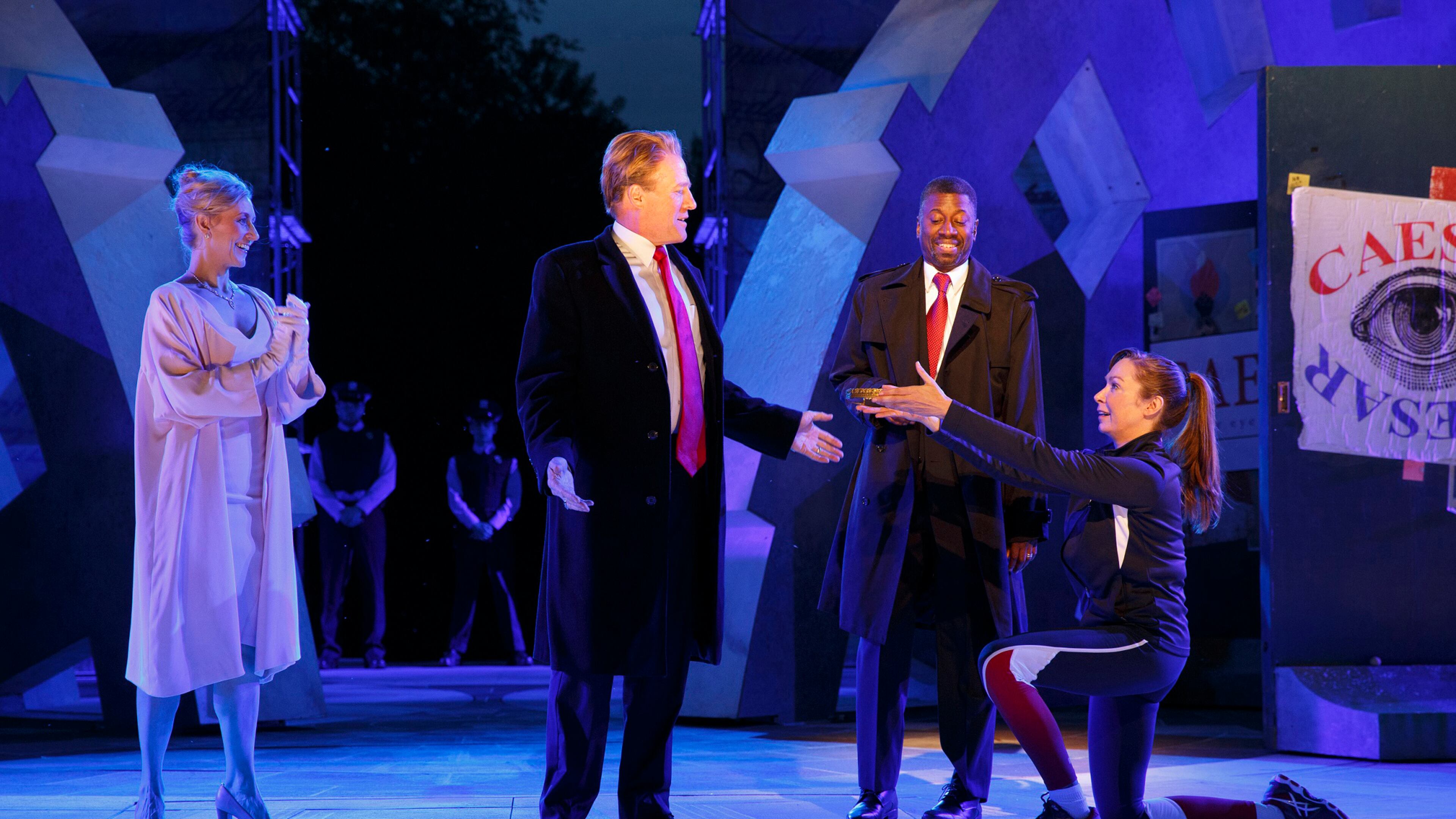 In this May 21 file photo provided by The Public Theater, Tina Benko, left, portrays Melania Trump in the role of Caesar's wife, Calpurnia, and Gregg Henry, center left, portrays President Donald Trump in the role of Julius Caesar during a dress rehearsal of The Public Theater's Free Shakespeare in the Park production of Julius Caesar in New York. Joan Marcus/The Public Theater via AP