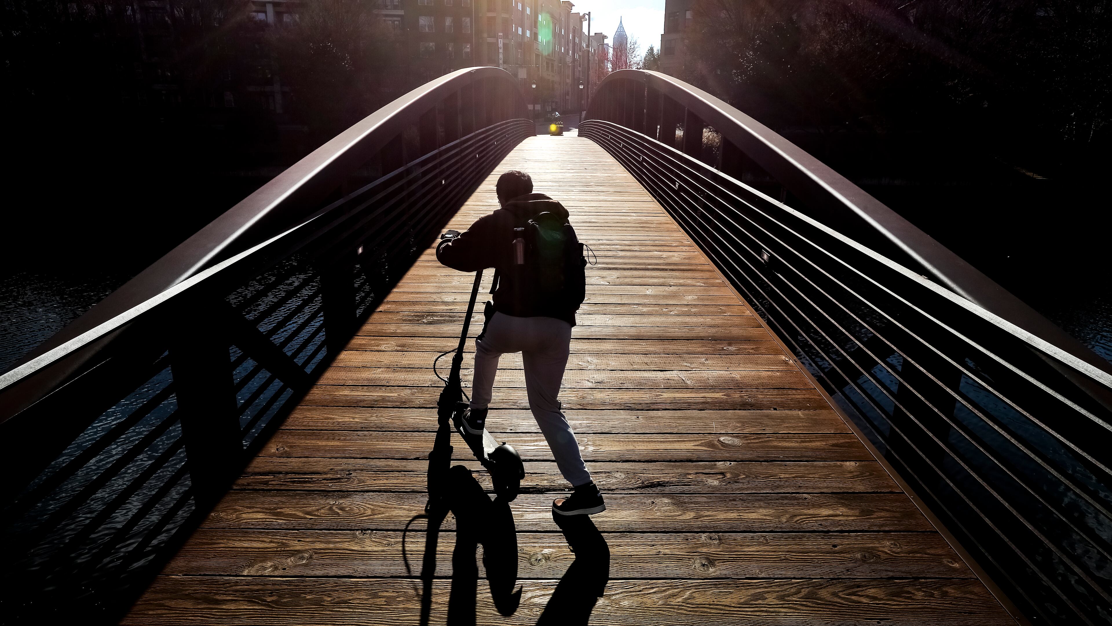 Georgia Tech student, Mann Patel from India majoring in environmental engineering heads across the bridge on his scooter at 17th Street and Mecaslin Street near Atlantic Station in downtown Atlanta on his way to class braving the cold brisk winds Wednesday morning.