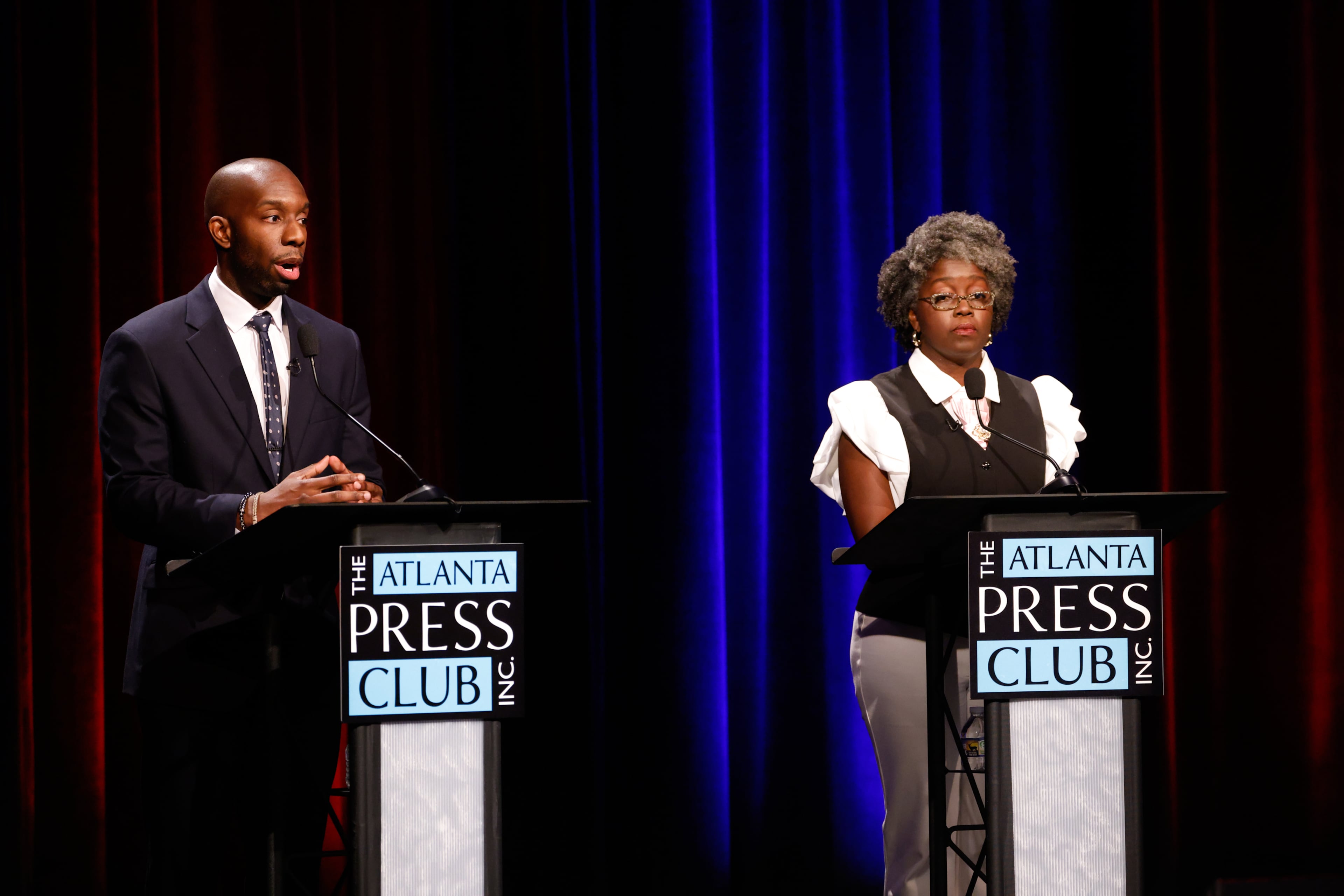 Democratic candidate for Congress, Everton Blair (left) speaks to candidate Jasmine Clark at the Atlanta Press Club Loudermilk-Young District 13 primary election debate at Georgia Public Broadcasting, Monday, April 27, 2026, in Atlanta. (Arvin Temkar/AJC)