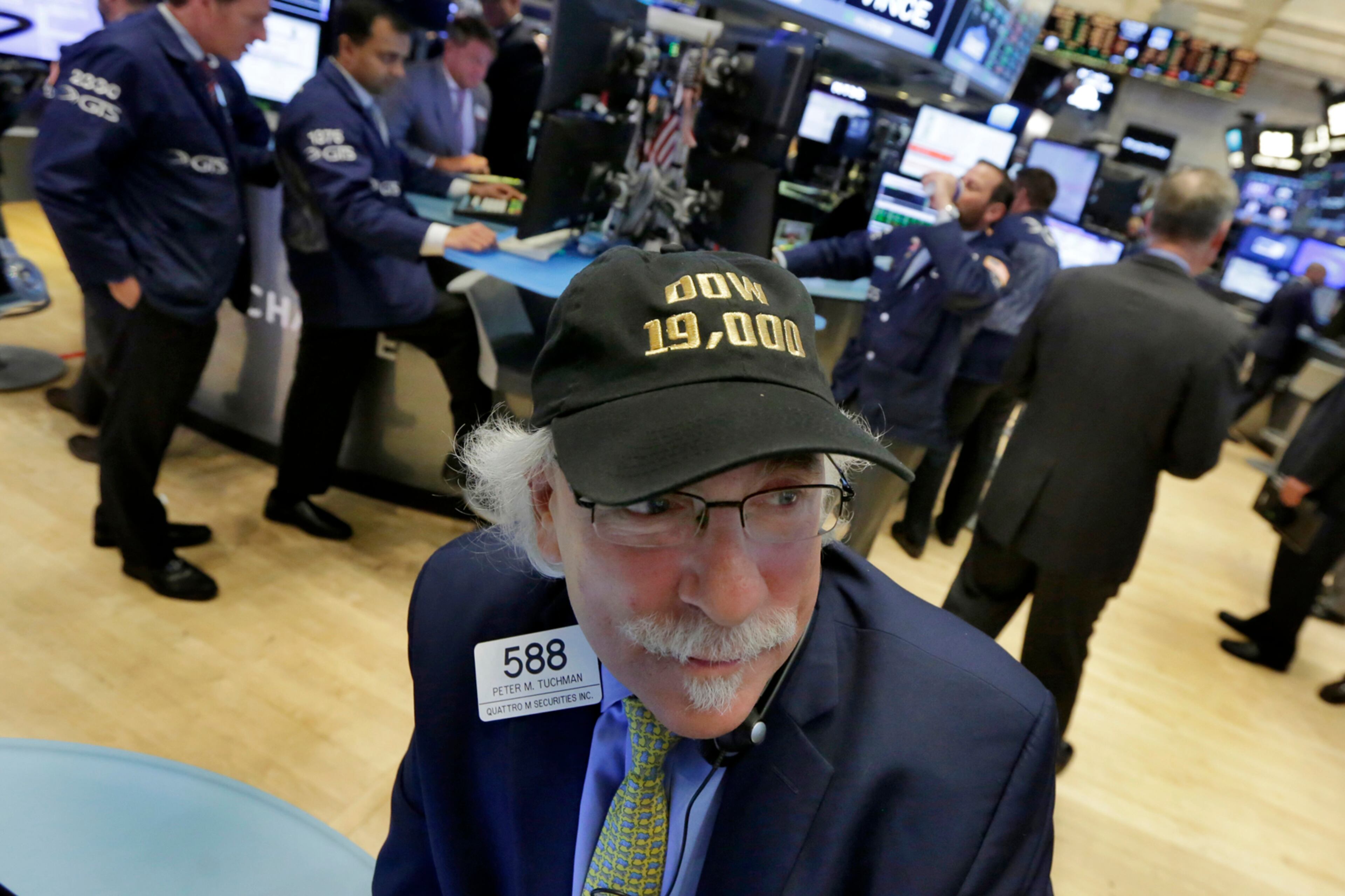 Trader Peter Tuchman wears his "Dow 19,000" cap on the floor of the New York Stock Exchange, Monday, Nov. 21, 2016. U.S. stocks are rising in early trading as the price of oil jumps and energy companies move higher, keeping indexes at record highs. (AP Photo/Richard Drew)