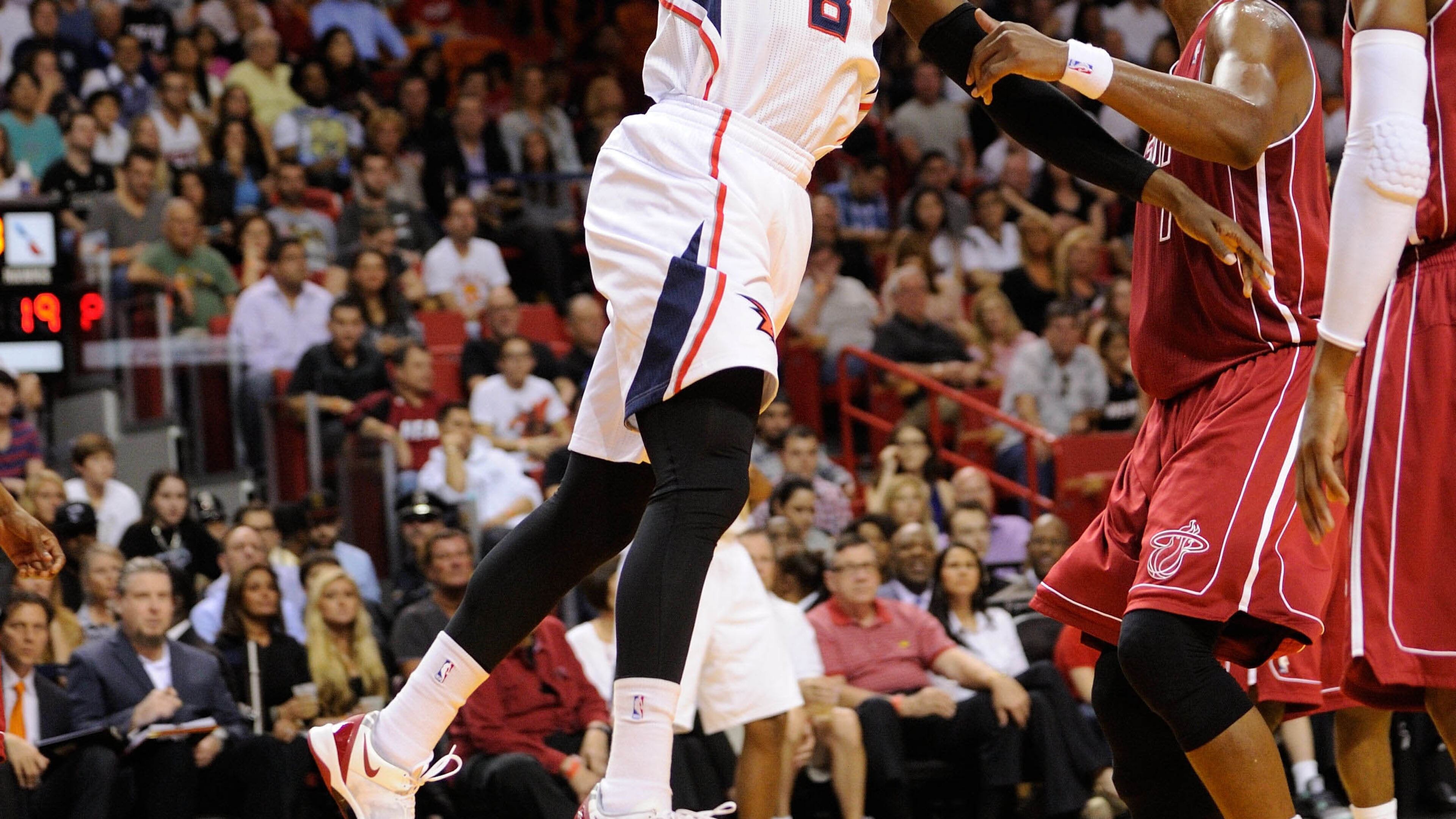 Dec 23, 2013; Miami, FL, USA; Atlanta Hawks point guard Shelvin Mack (8) drives to the basket as Miami Heat center Chris Bosh (1) looks on during the first half at American Airlines Arena. Mandatory Credit: Steve Mitchell-USA TODAY Sports