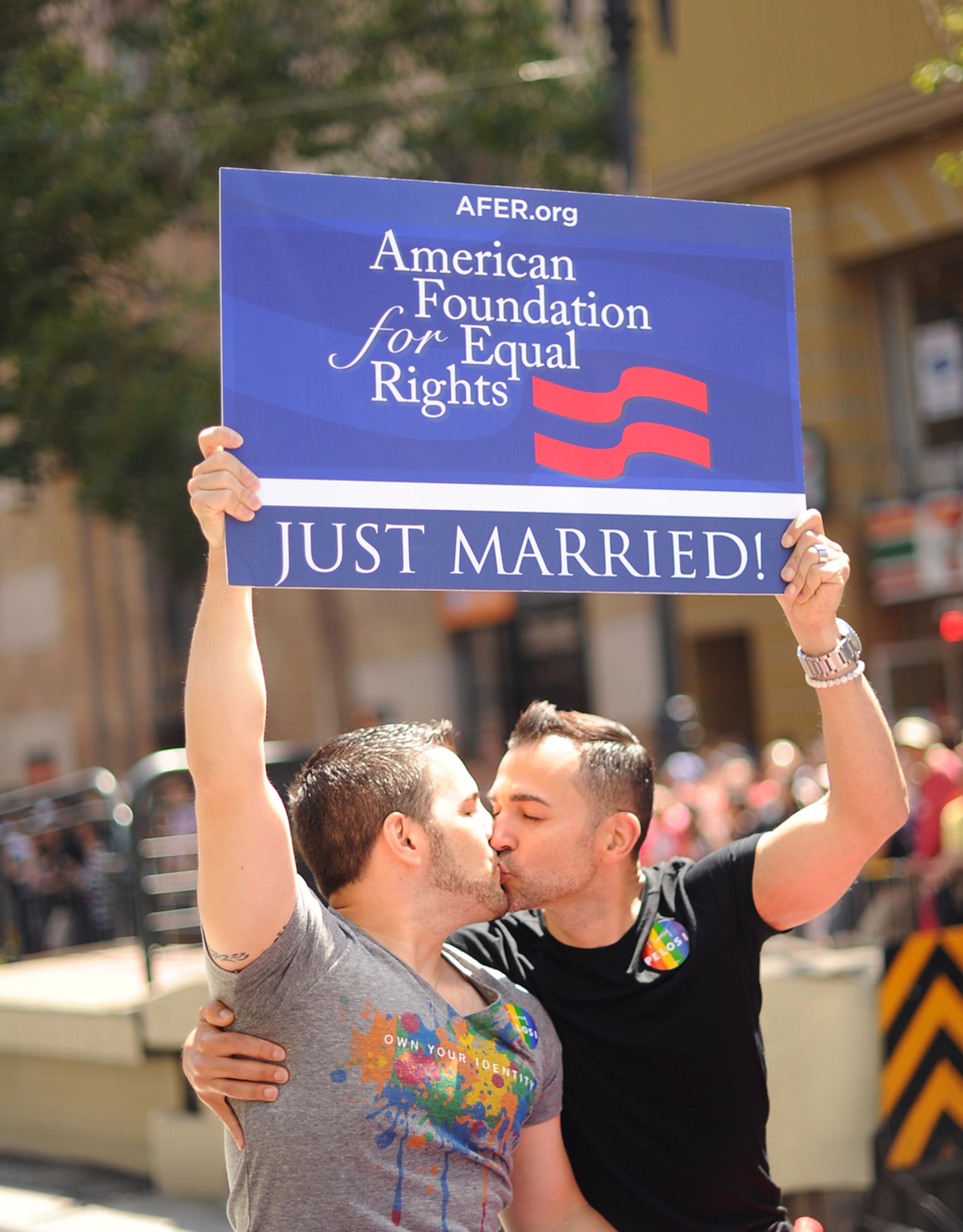 Proposition 8 plaintiffs Paul Katami, right, and Jeff Zarrillo kiss while riding in San Francisco's 43rd annual Gay Pride parade Sunday, June 30, 2013. The couple wed on Friday after a U.S. Supreme Court decision cleared the way for same-sex marriages in California. (AP Photo/Noah Berger)
