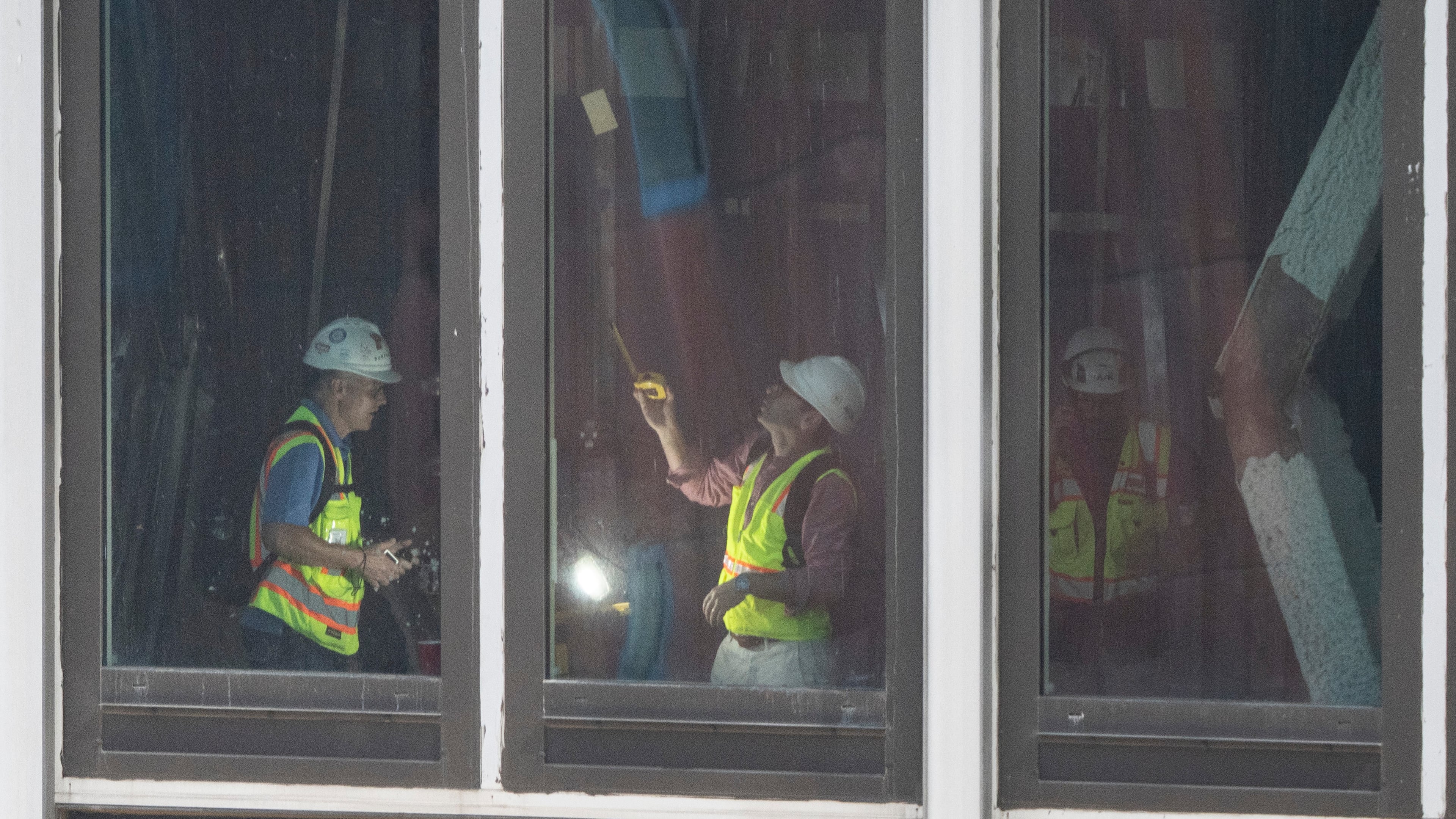 People inspect a buckled support beam inside 235 East 42nd Street, Wednesday, July 8, 2026, in New York. (AP Photo/Yuki Iwamura)