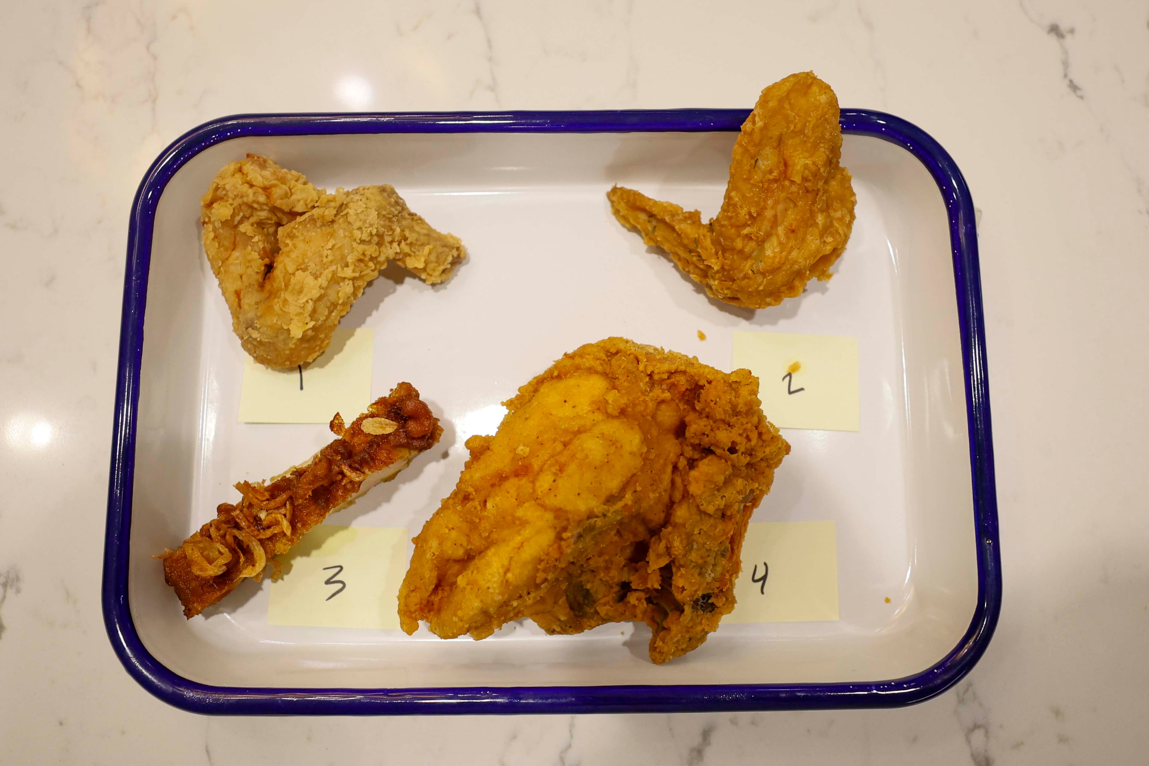 A tray of fried chicken from bb.q Chicken, Pelicana Chicken, Pink Lotus Thai Restaurant and Publix Deli is shown at The Atlanta Journal-Constitution office, where a food expert and a guest will participate on Tuesday, Aug. 25, 2026, to determine Atlanta’s best fried chicken. (Miguel Martinez/AJC)
